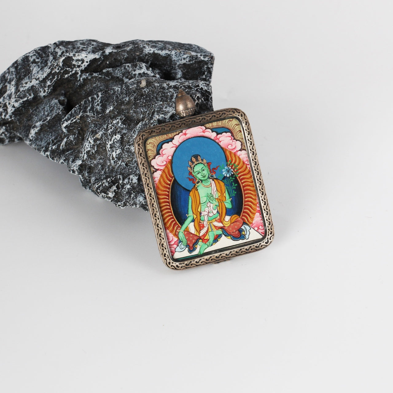  The Rebgong Green Tara Thangka pendant displayed as a sacred amulet for compassion and swift action, embodying Tibetan Buddhist tradition.

