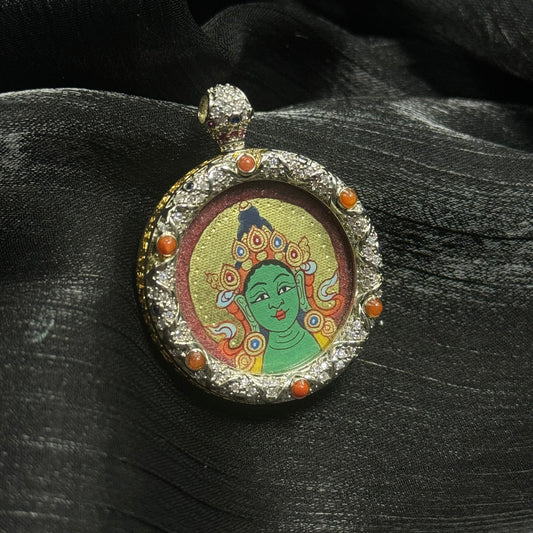 A 3x3cm hand-painted Rekong Red-Gold Green Tara Buddha Head Thangka pendant featuring the Liberator from Eight Dangers, representing compassion and protection in Buddhist tradition.
