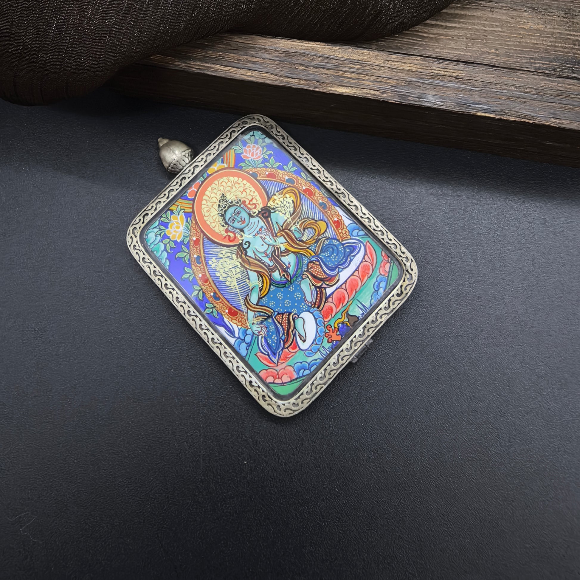  A 3.5x4.5cm hand-painted Rekong Green Tara (绿度母) Thangka pendant with 925 silver featuring the goddess of compassion, representing protection and liberation in Buddhist tradition.
