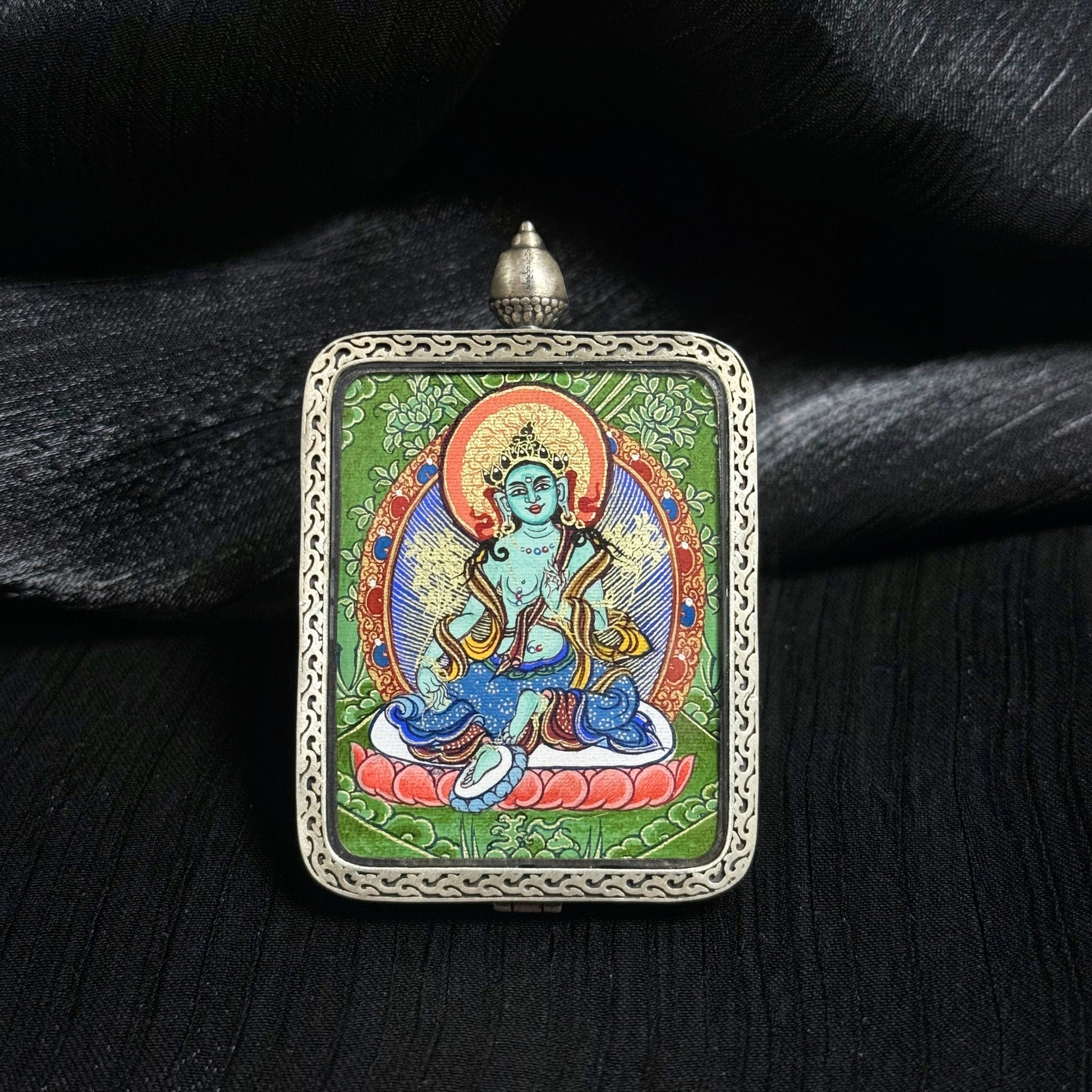 Close-up detail of the Rekong Cuiying Green Tara Thangka painting showing natural mineral pigments.
