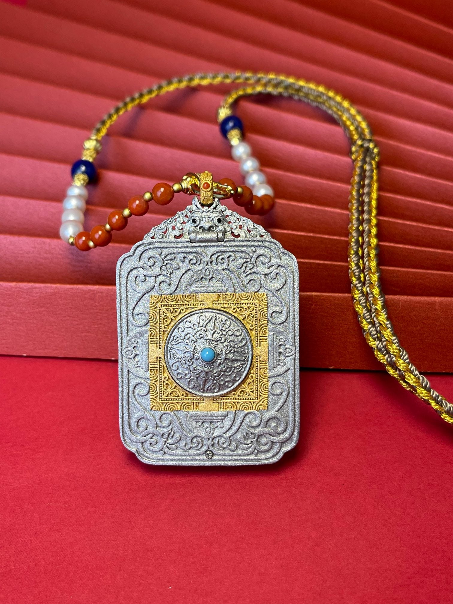  The Rekong Green Tara Thangka pendant with hand-woven cord displayed as a sacred amulet for compassion and liberation from suffering, embodying Buddhist tradition.
