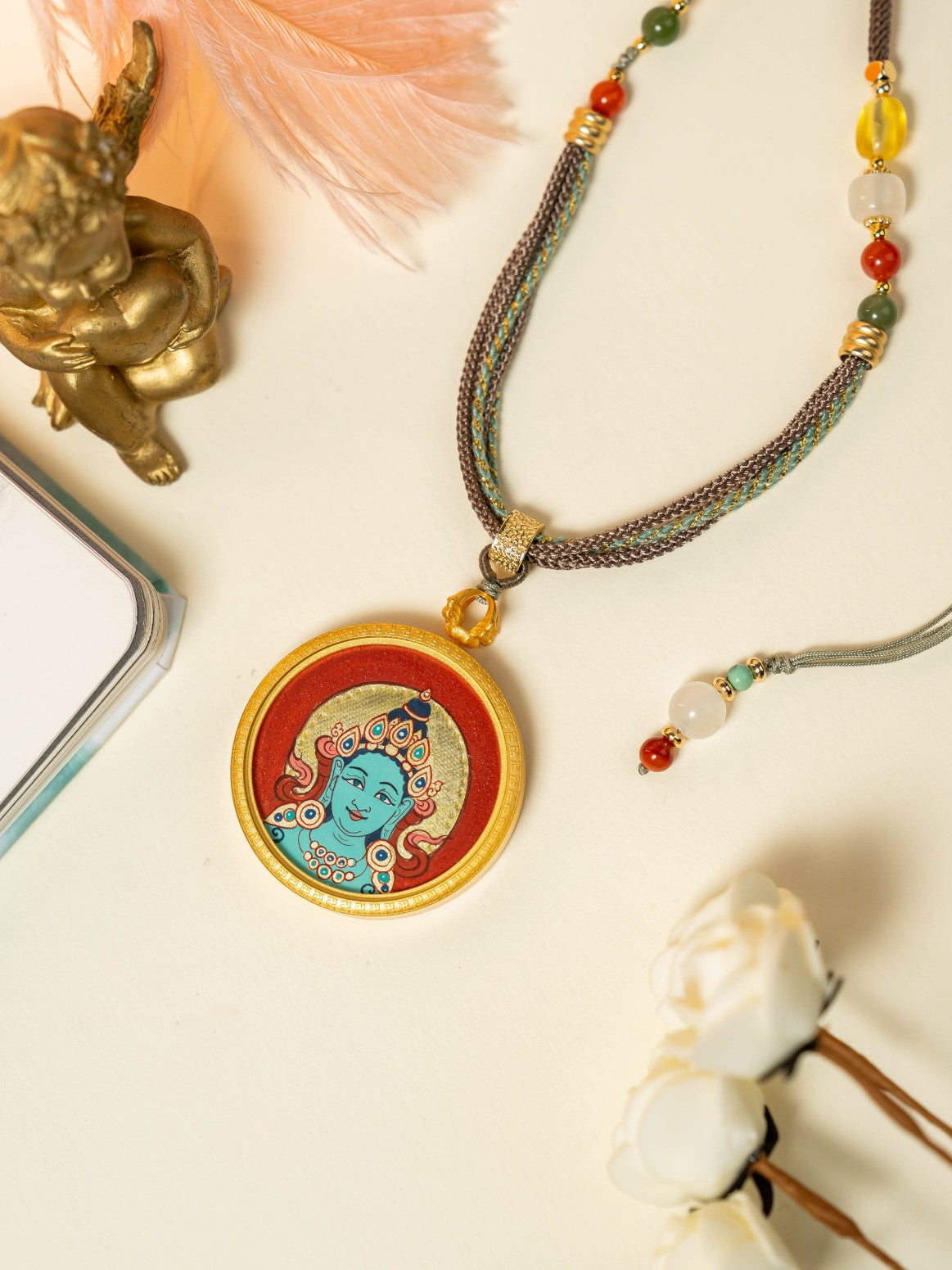  Close-up detail of the Rekong Red Gold Green Tara Thangka showing hand-painted mineral pigments, cinnabar and gold, showcasing the masterful artistry and rich texture.

