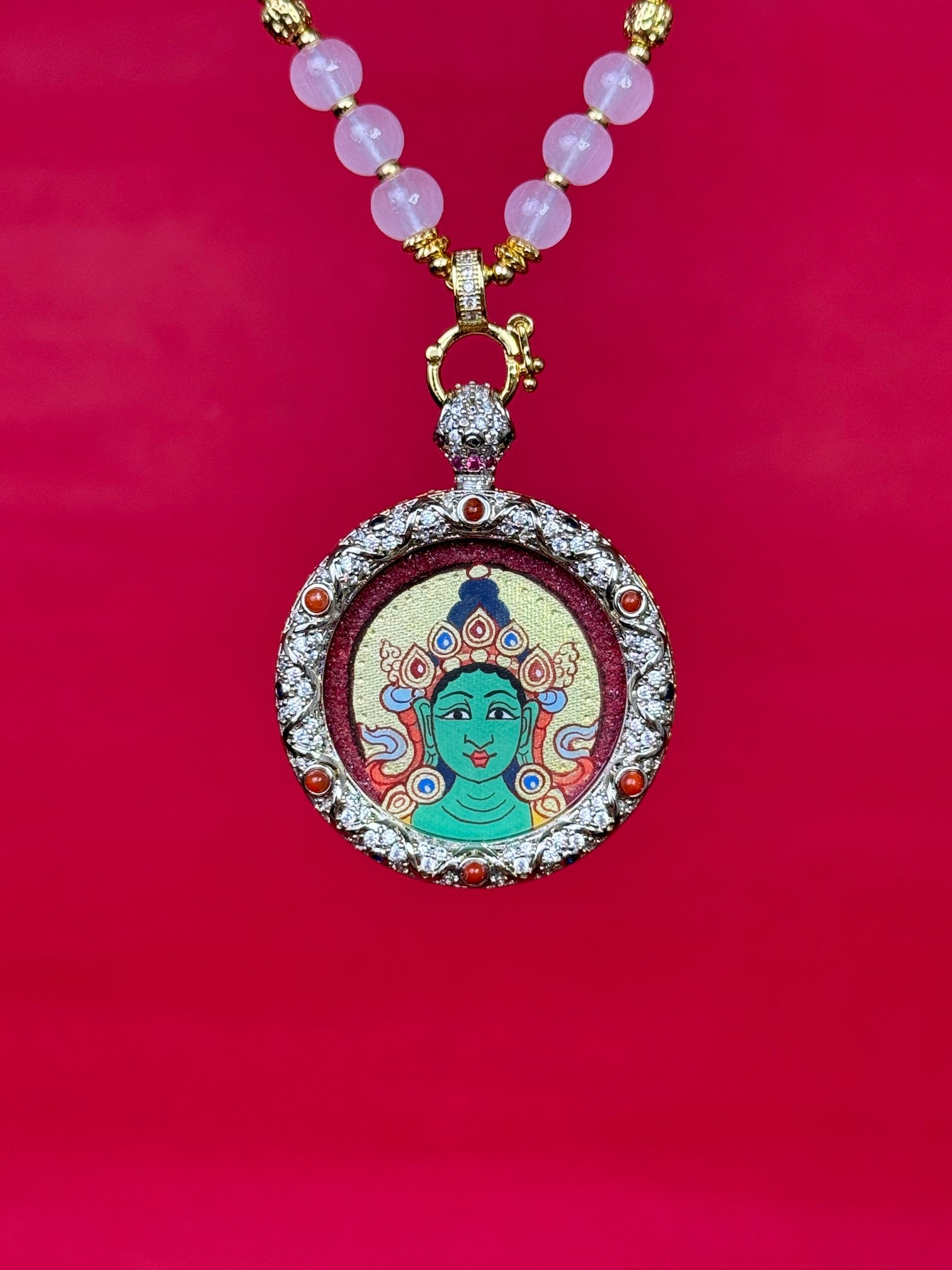  Close-up detail of the Rekong Red Gold Green Tara Thangka showing hand-painted mineral pigments, cinnabar and gold, showcasing the masterful artistry and rich texture.
