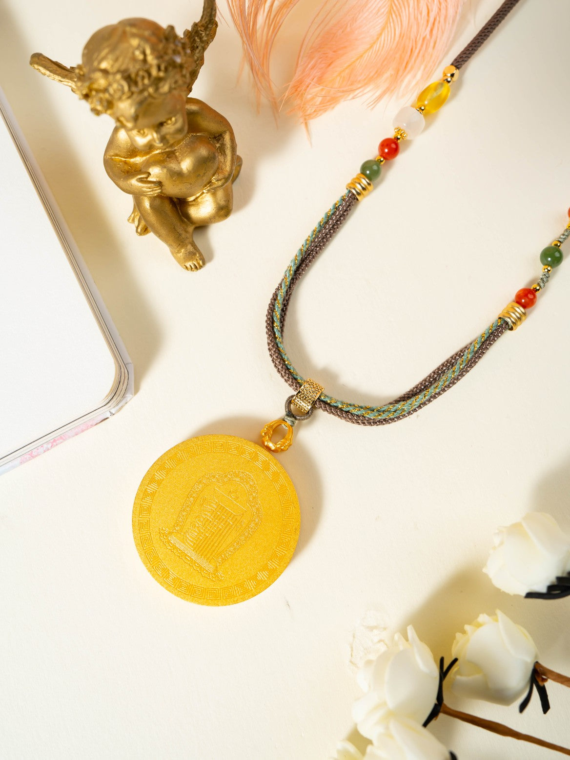 The Rekong Red Gold Green Tara Thangka pendant with copper casing displayed as a sacred amulet for relieve suffering and all wishes fulfilled, embodying Buddhist tradition.
