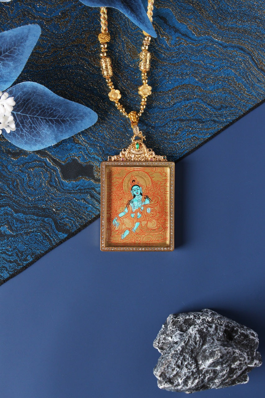 Close-up detail of the Tibetan Buddhist Green Tara Thangka painting showing intricate natural mineral pigment work and serene expression, showcasing the masterful artistry of Tibetan lineage painters.
