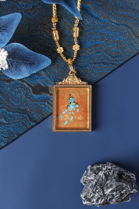 Close-up detail of the Tibetan Buddhist Green Tara Thangka painting showing intricate natural mineral pigment work and serene expression, showcasing the masterful artistry of Tibetan lineage painters.
