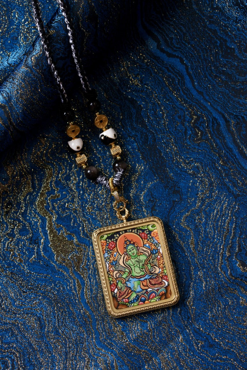 An emerald Green Tara pendant designed to enhance meditation energy, depicting the Buddhist goddess of compassion and wisdom in Tibetan culture.