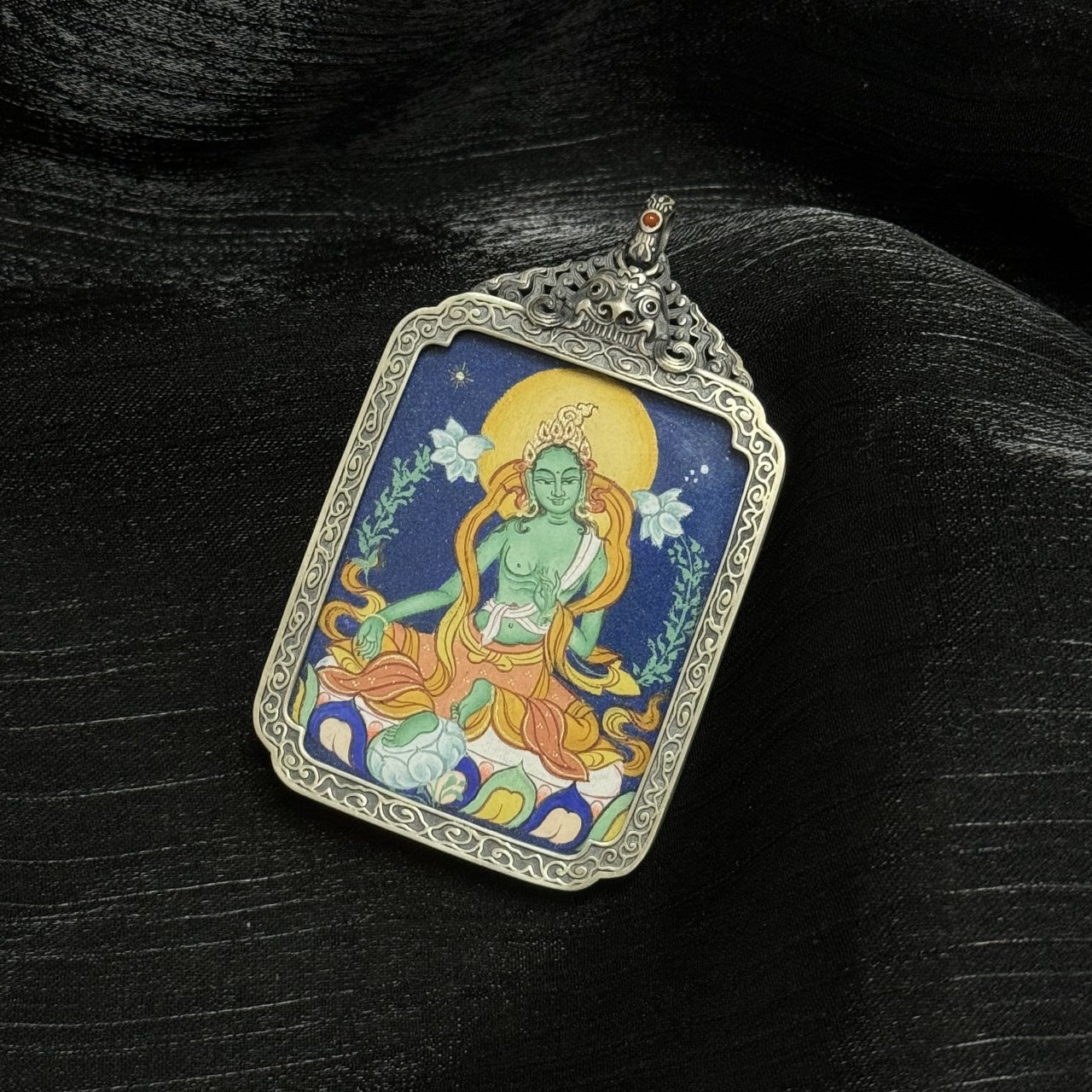 Hand-painted Tibet Coarse Green Tara Thangka pendant featuring the saviour from eight dangers, encased in vintage silver, representing compassion and wisdom in Tibetan Buddhist tradition.

