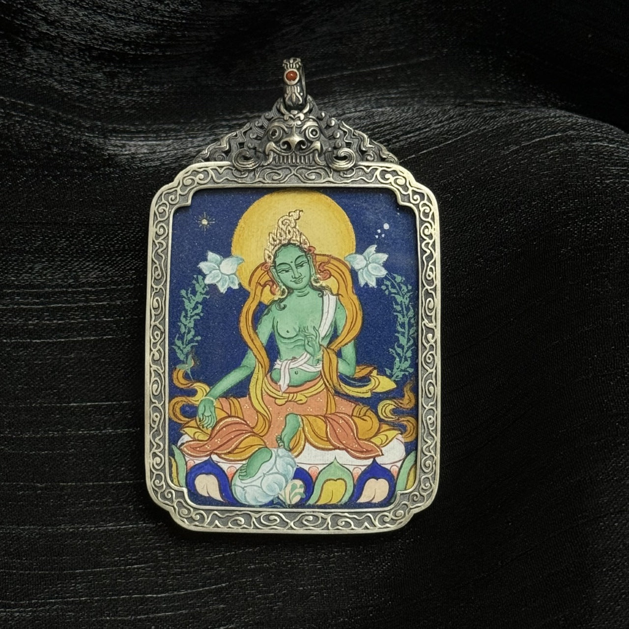 The Tibet Coarse Green Tara Thangka pendant displayed as a sacred amulet for compassion and wisdom, embodying Tibetan Buddhist tradition.
