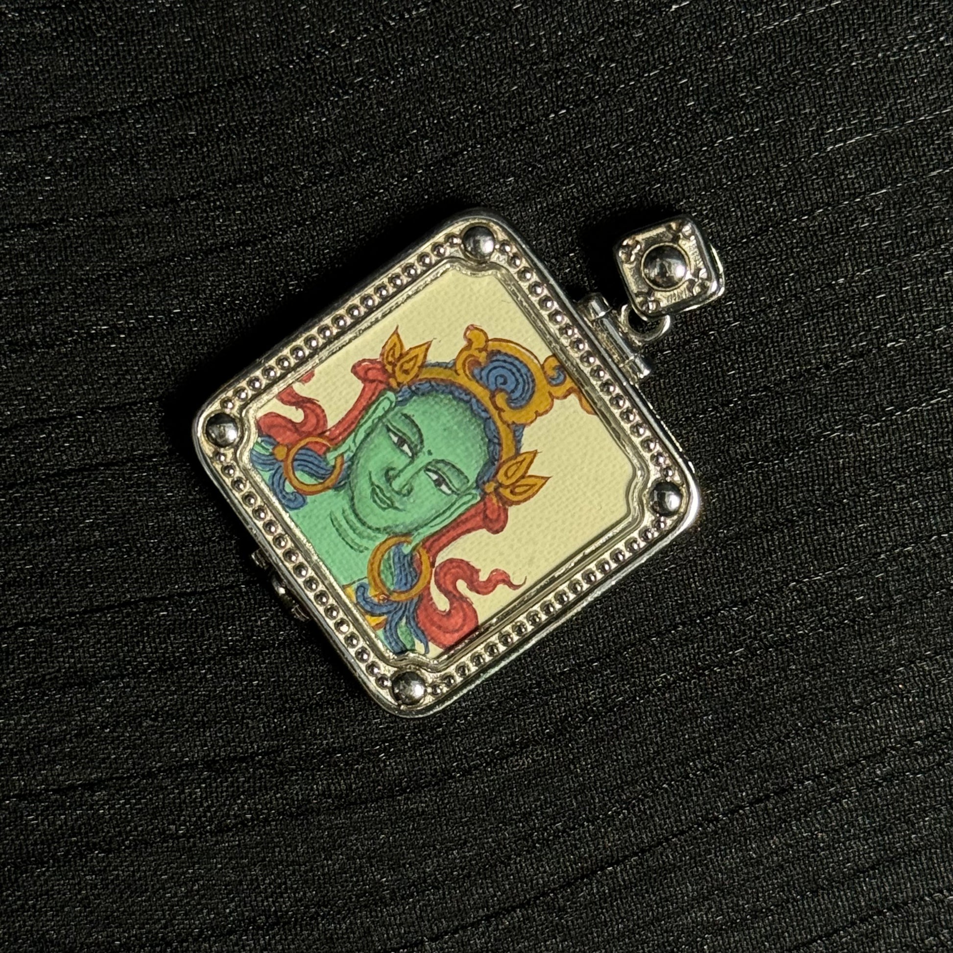 Close-up detail of the Tibet Green Tara Thangka painting showing natural mineral pigments, showcasing the masterful artistry of Tibetan lineage painters.
