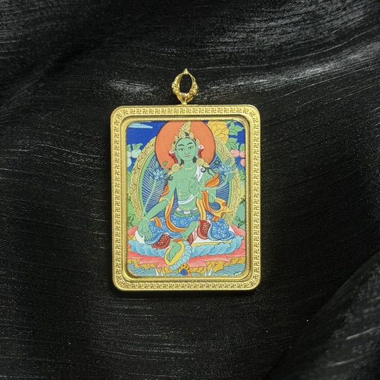  A 3.5x4.5cm hand-painted Tibet Elegant Green Tara Thangka pendant featuring the Goddess of Compassion and Swift Action, encased in titanium steel, representing compassion and success in Tibetan Buddhist tradition.
