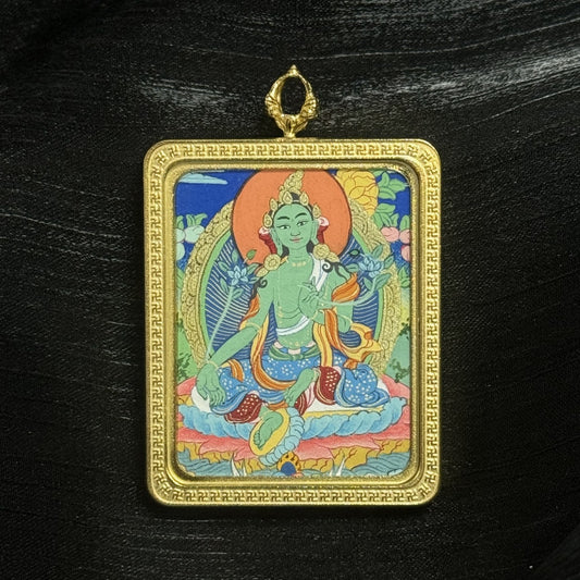 The Tibet Elegant Green Tara Thangka pendant displayed as a sacred amulet for compassion, love, and career success, embodying Tibetan Buddhist tradition.
