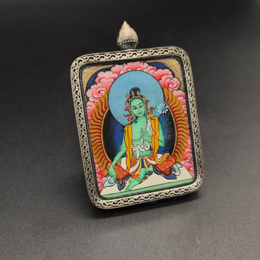  A 3.5x4.5cm hand-painted Tibet Red Cloud Green Tara (绿度母) Thangka pendant with 925 silver featuring the goddess of compassion, representing protection and liberation in Buddhist tradition.
