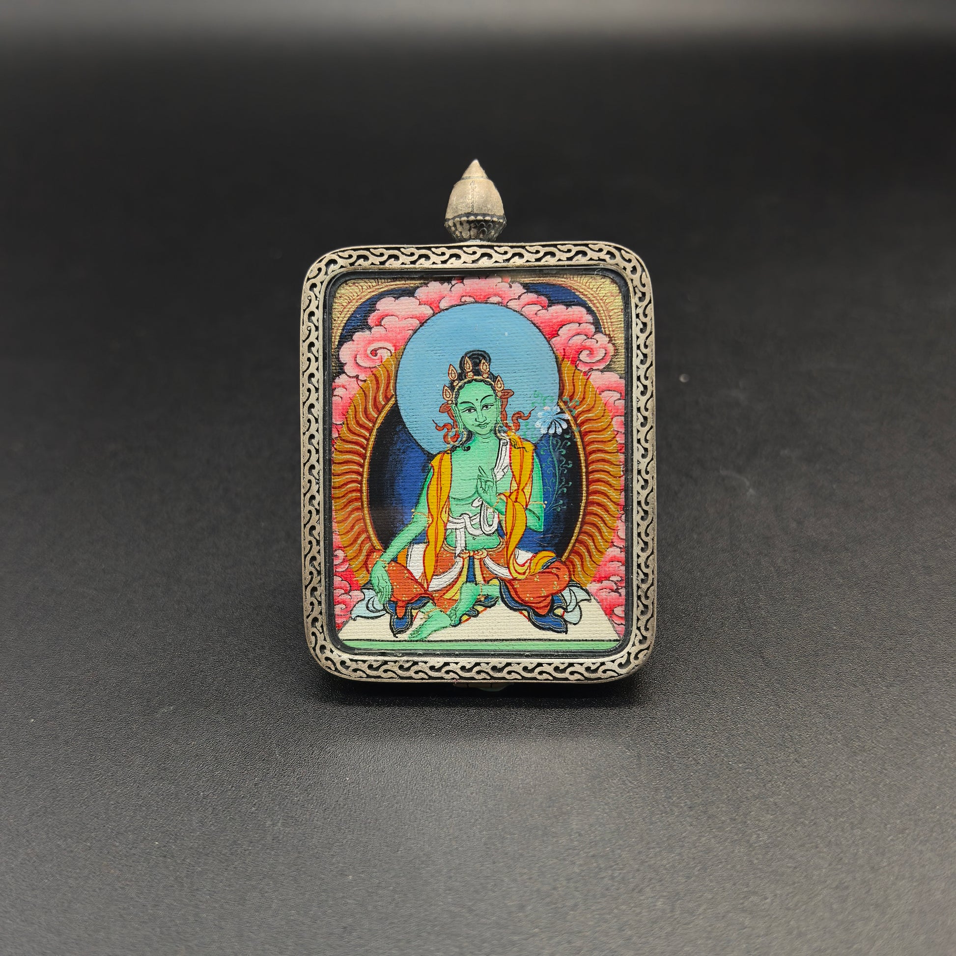  Close-up detail of the Tibet Red Cloud Green Tara Thangka painting showing natural mineral pigments, showcasing the masterful artistry of the hand-painted tradition.
