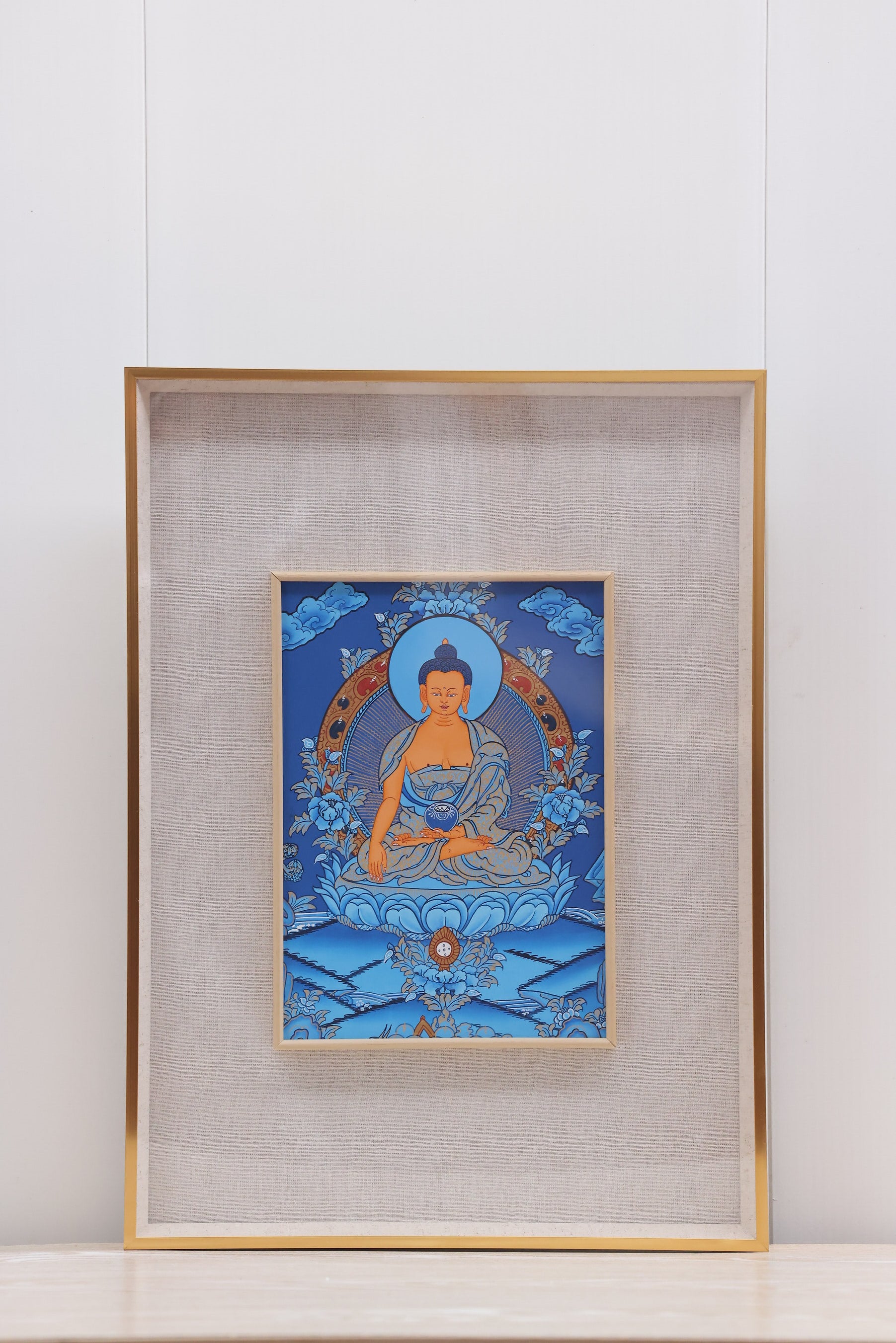 Golden line blue thangka showing Shakyamuni Buddha seated in lotus posture, Tibetan Buddhist art