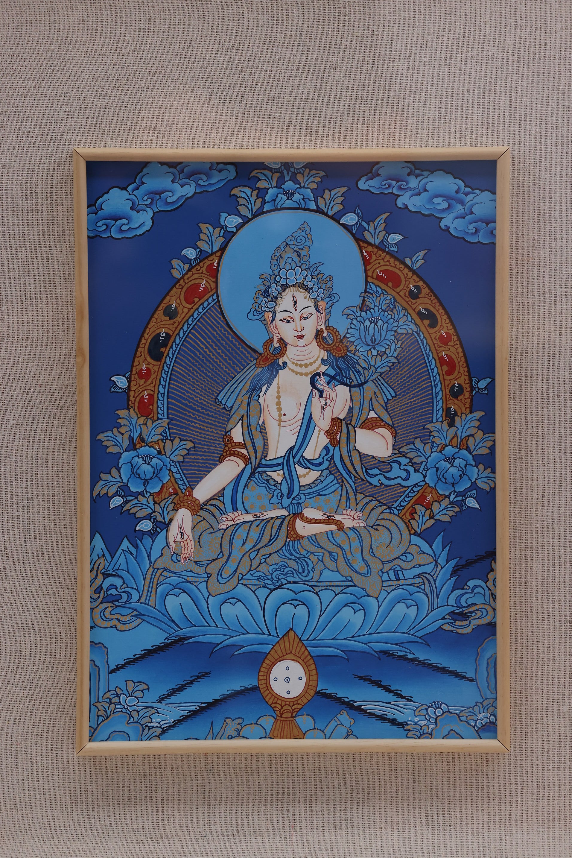 Blue Thangka White Tara artwork showing the goddess of long life, compassion, and family protection in Tibetan Buddhist tradition.