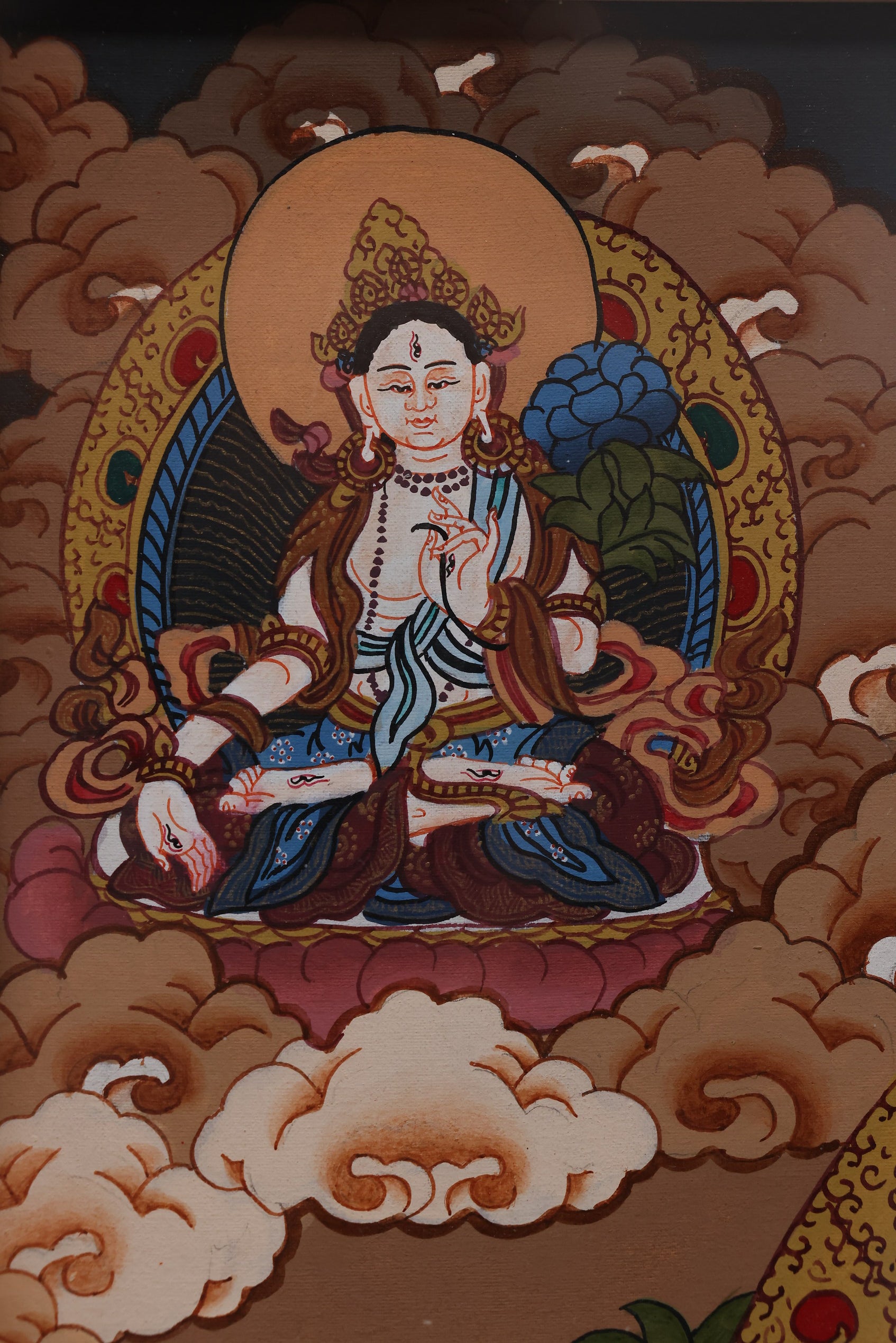 Alt Text: Traditional Tibetan art Thangka showing the Thousand-Armed Bodhisattva, a symbol of divine protection.