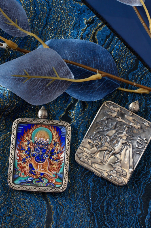Tibetan Buddhist thangka pendant depicting Vajrakilaya Heruka, a wrathful protector deity symbolizing spiritual power and transformation.