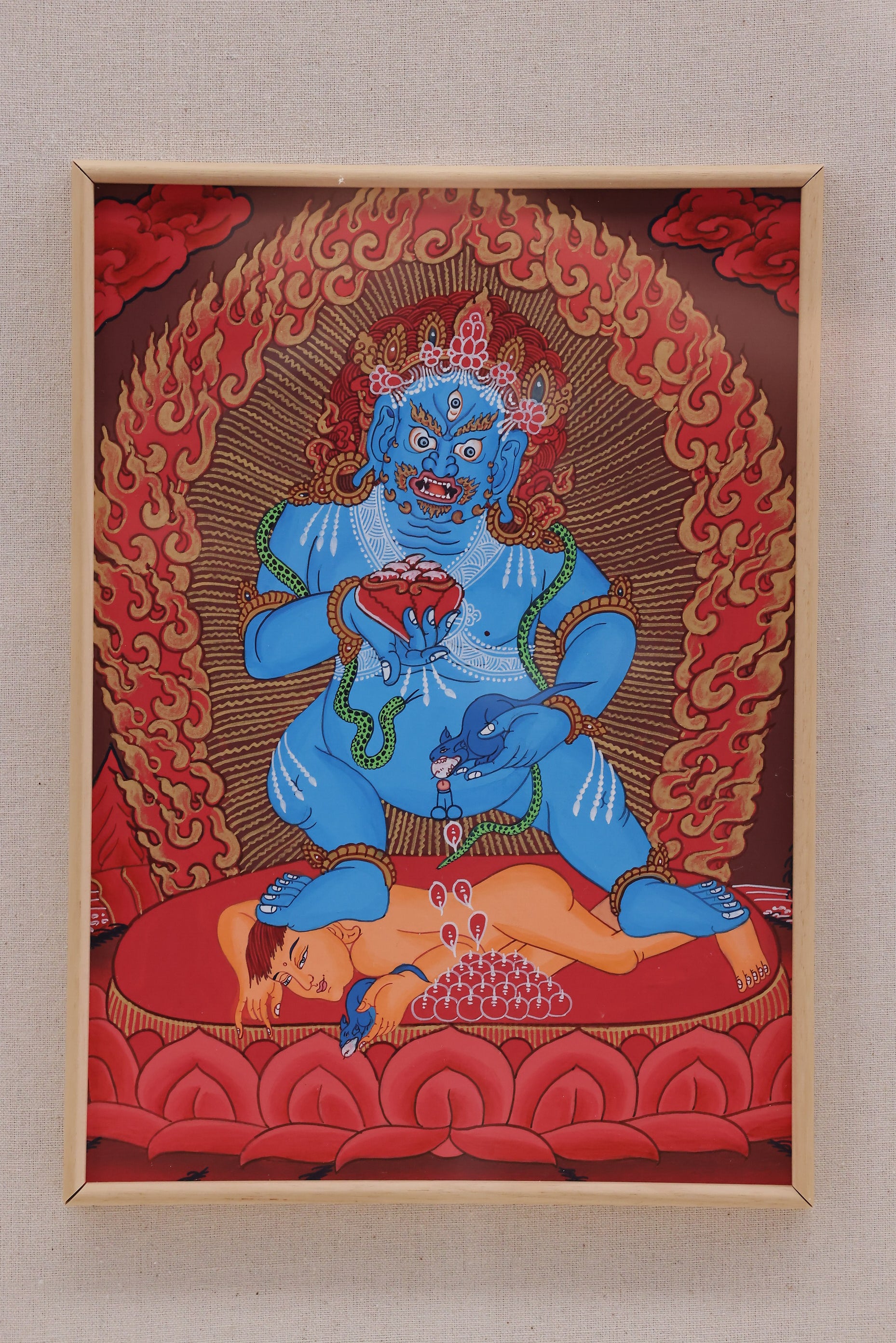 Black Jambhala prosperity thangka in red style, representing financial stability and removal of poverty in Tibetan Buddhism