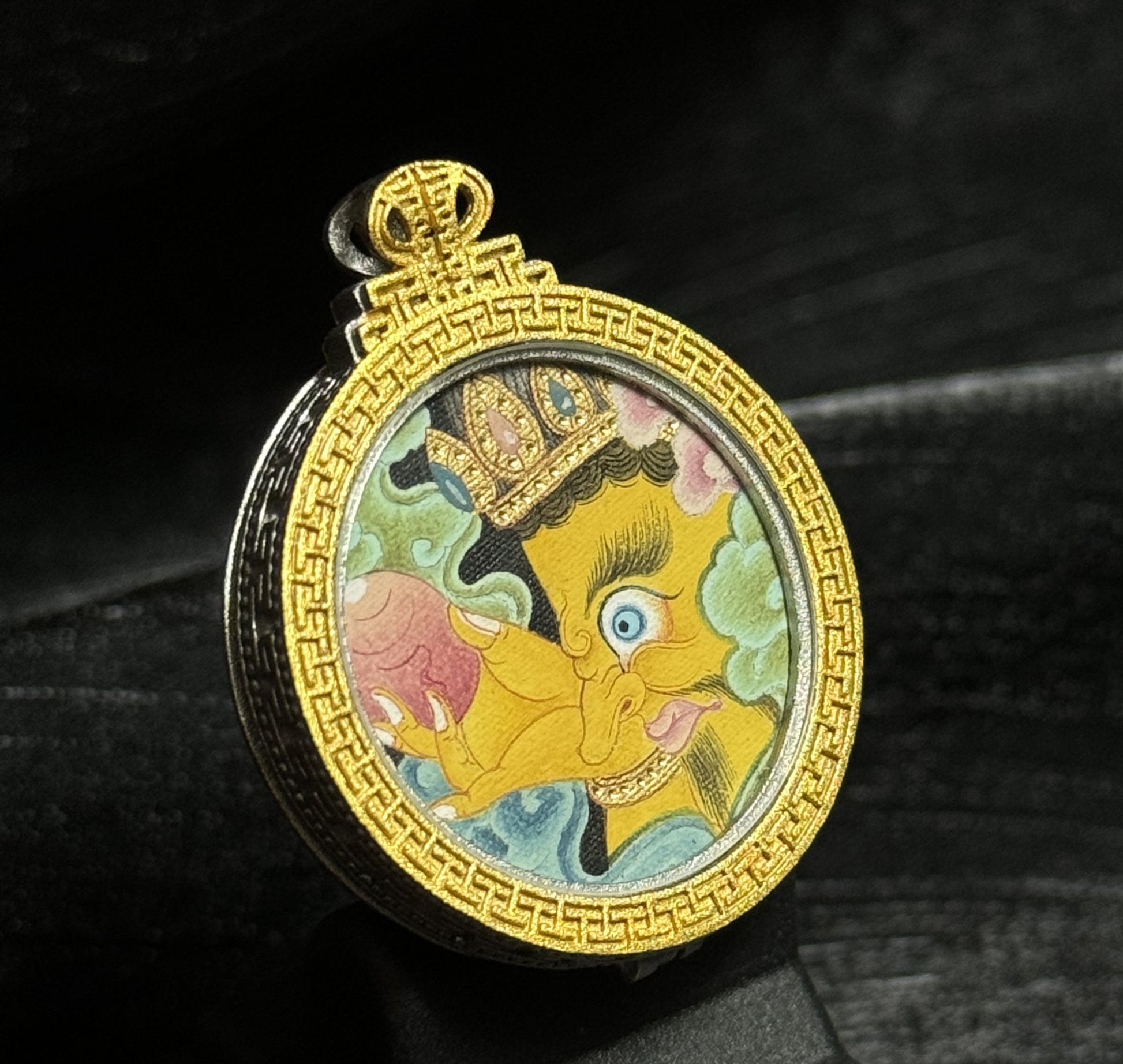  A 2.5x2.5cm hand-painted Tibet Jambhala (Wish-Fulfilling Wealth Deity) Thangka pendant featuring the Bumpa jewel, representing wealth and blessing in Buddhist tradition.
