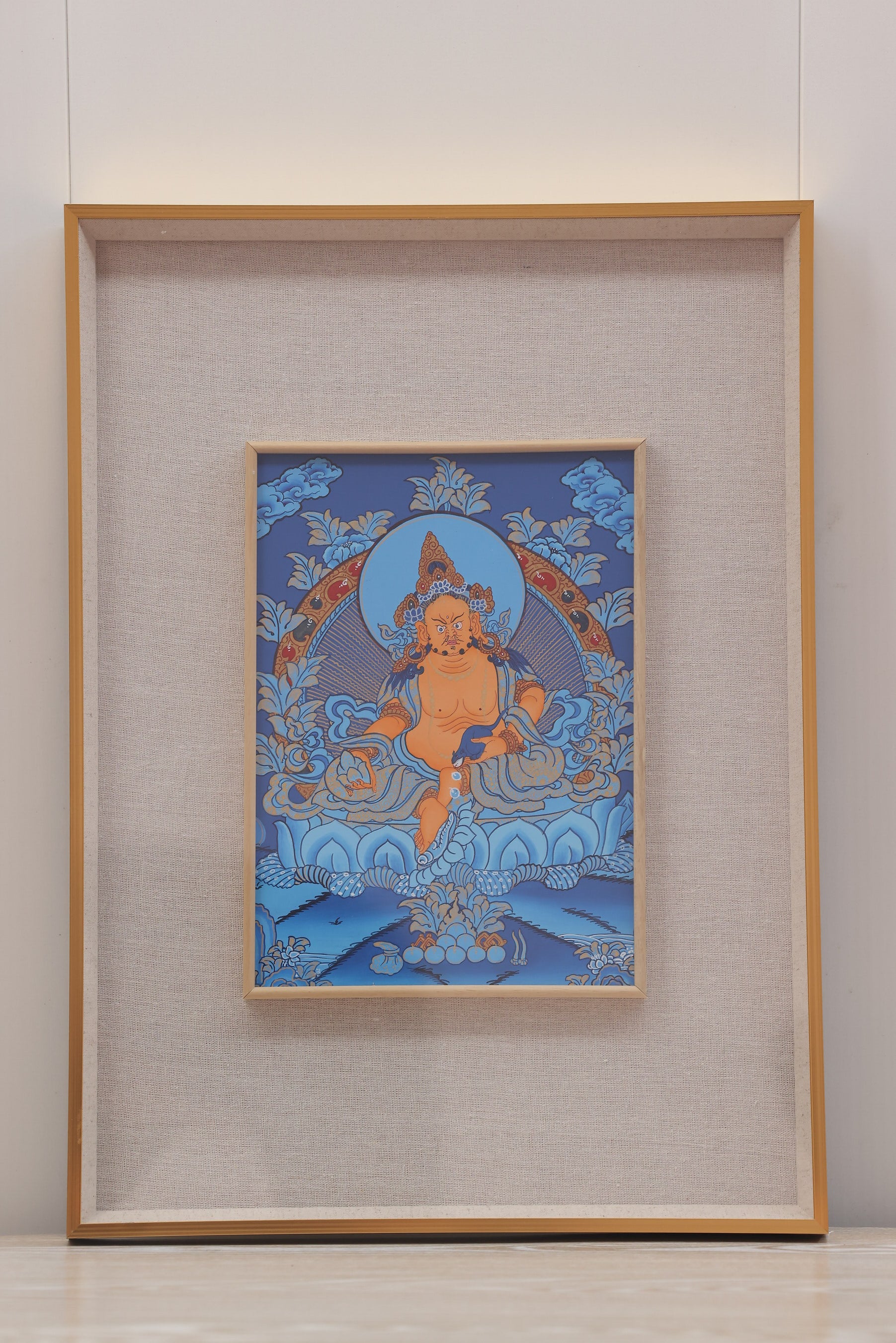 Traditional Tibetan Buddhist art of Yellow Jambhala, finely detailed thangka expressing wealth, merit, and compassionate giving