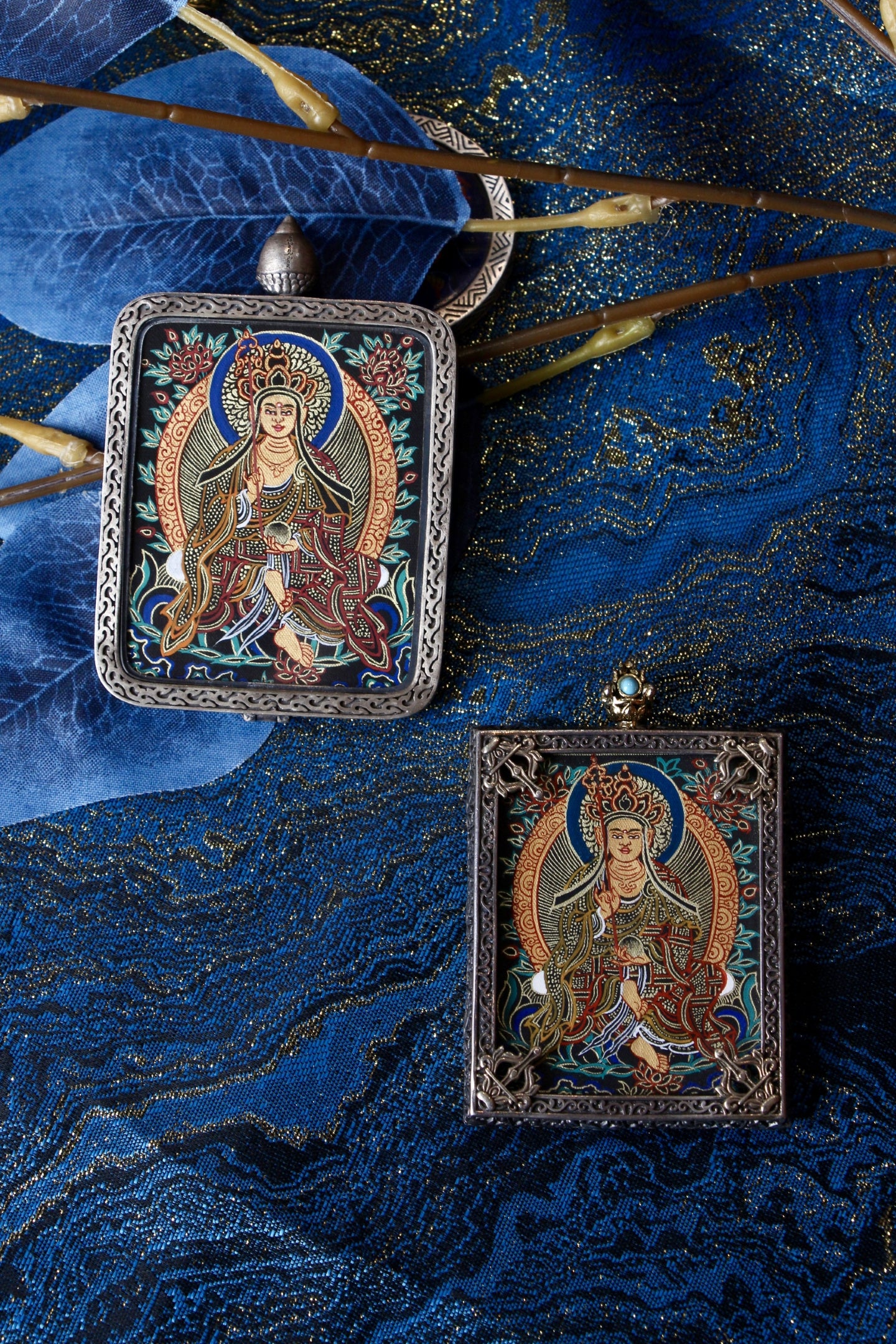 Macro view of the Kshitigarbha Thangka showing the meticulous layering of pure gold powder and the serene facial expression.