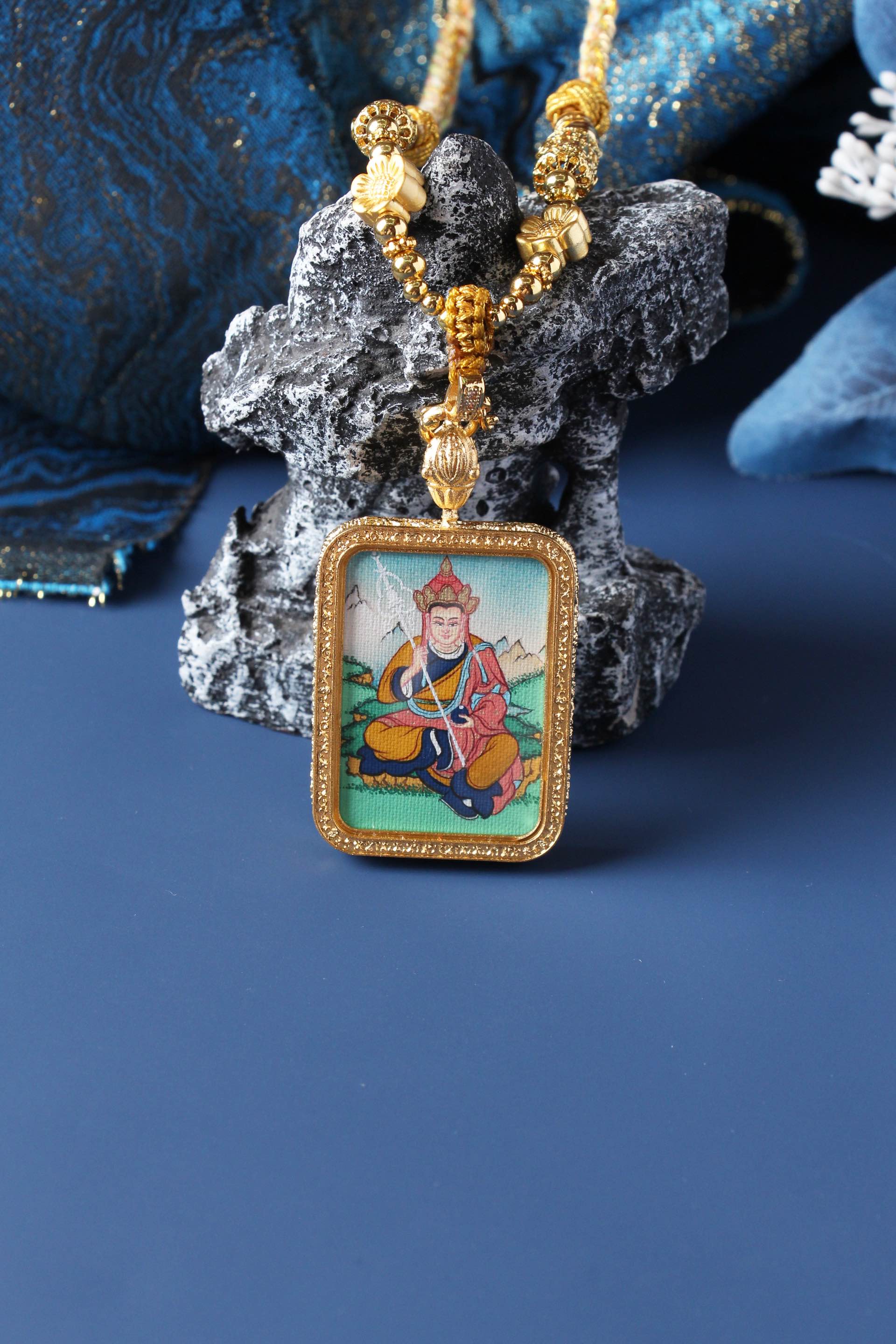 A 3.5x4.5cm hand-painted Tibetan Buddhist Ksitigarbha Bodhisattva Thangka pendant featuring the Bodhisattva of the Hell Beings, encased in exclusive 925 Sterling Silver, representing liberation and protection in Tibetan Buddhist culture.
