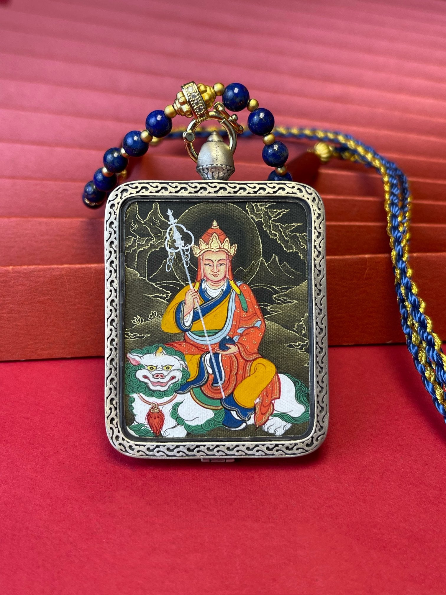 Hand-painted Rekong Ksitigarbha (地藏王菩萨) Thangka pendant 3.5x4.5cm with 925 silver casing and lapis cord featuring the Great Vow Bodhisattva, representing liberate beings and fulfil wishes in Buddhist tradition.
