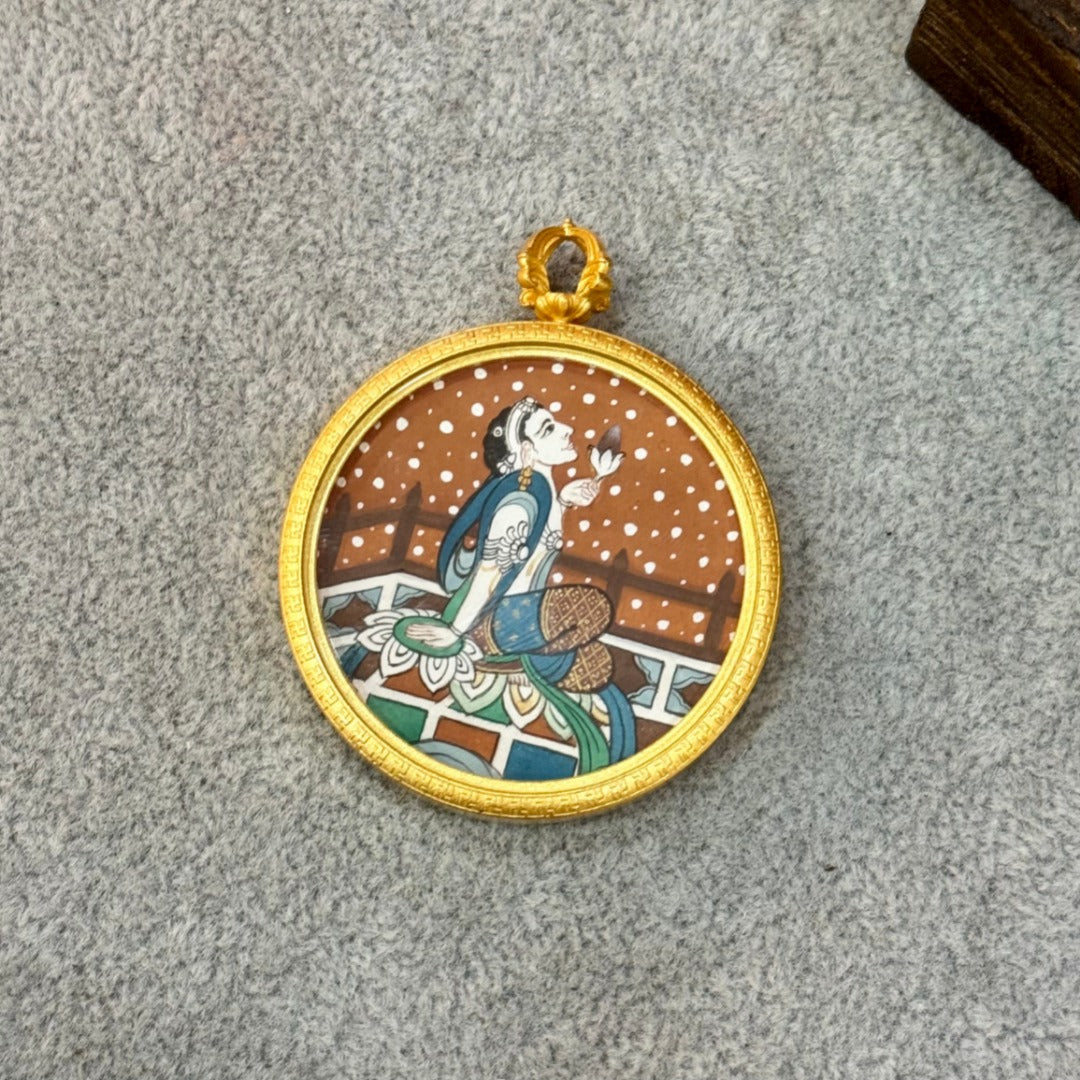  The Tibet Dunhuang Mural Lotus-Holding Avalokiteshvara Thangka pendant displayed as a sacred amulet for compassion and spiritual fulfillment, embodying Tibetan Buddhist tradition.

