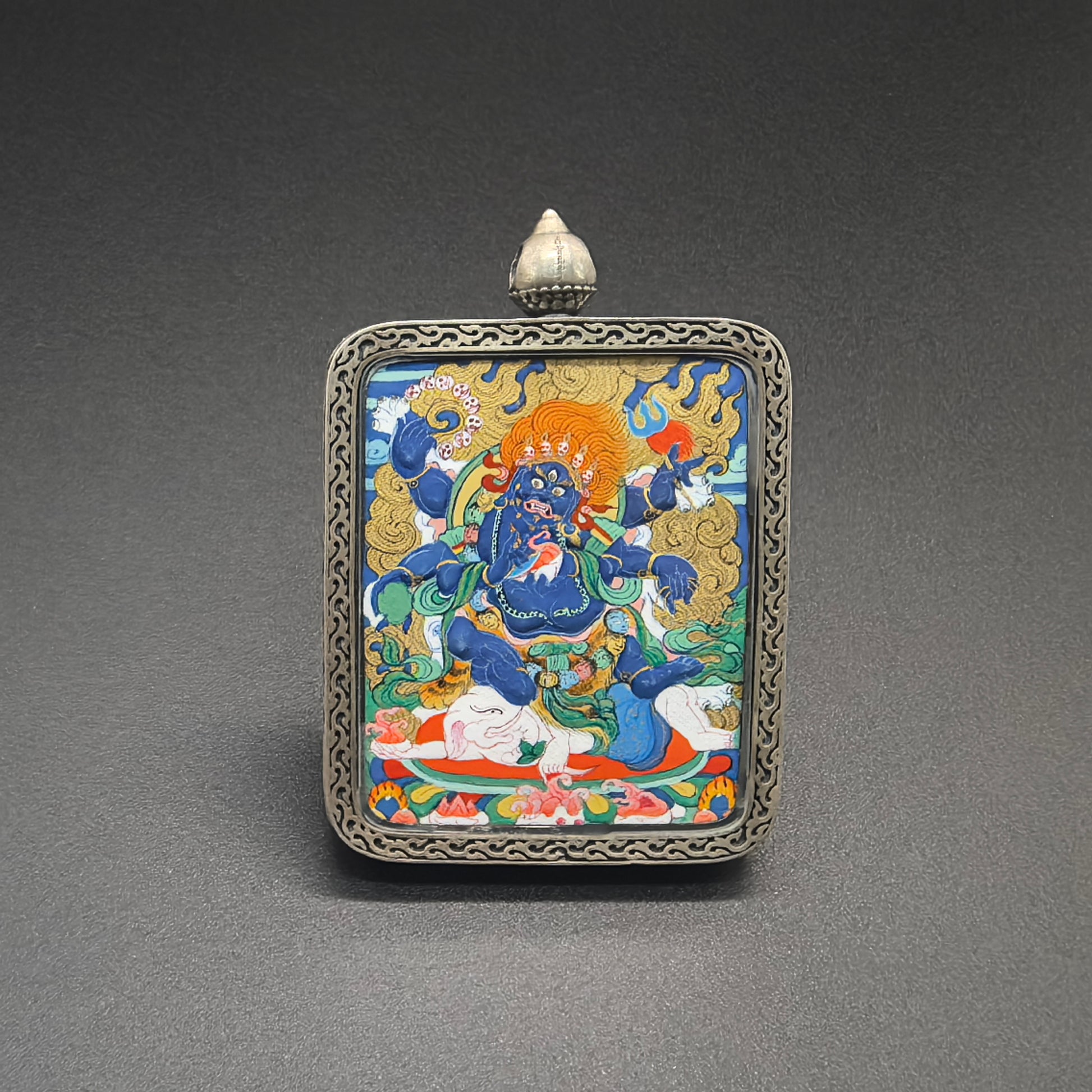  Detailed view of the presentation and casing for the Mahakala Cuiying Thangka pendant.
