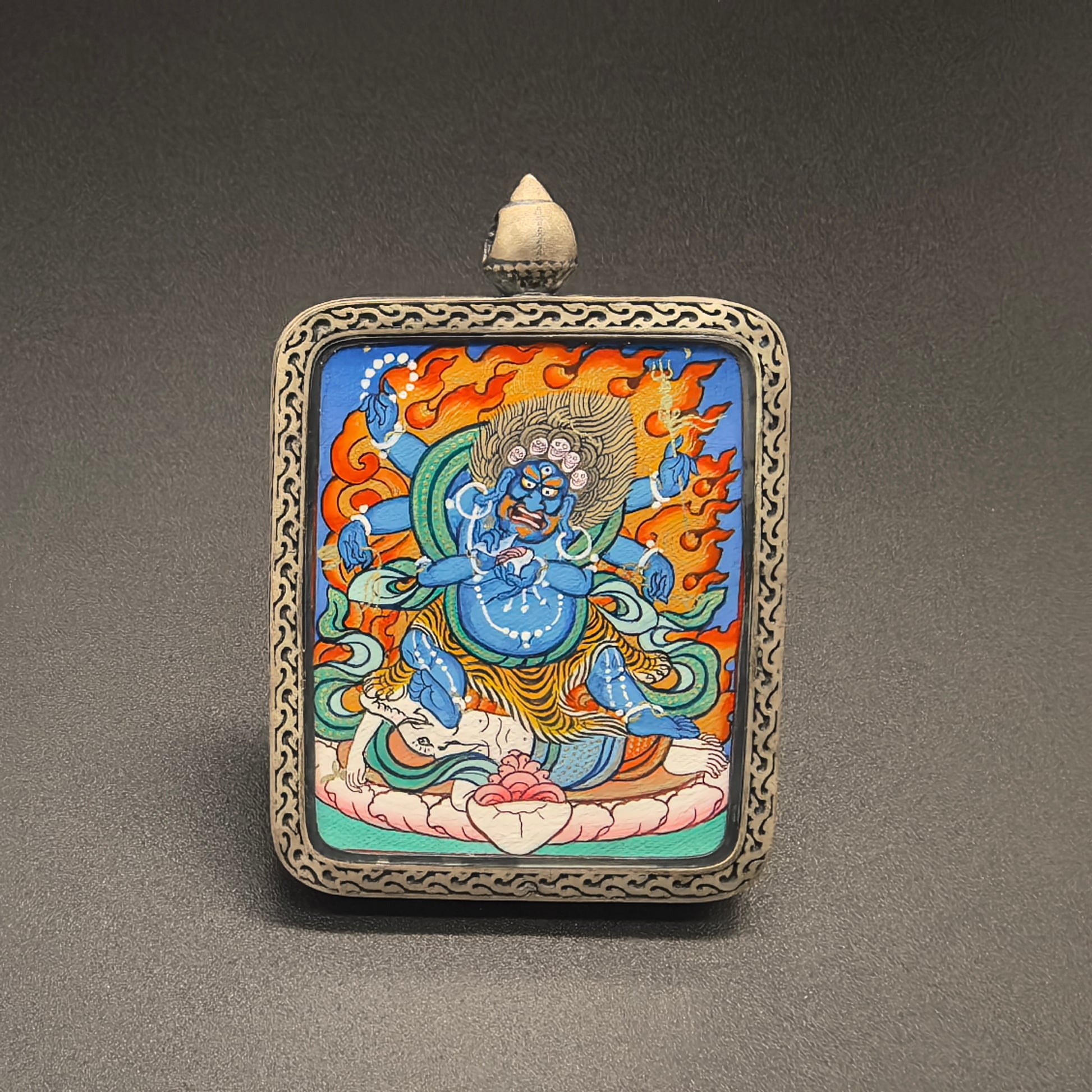 Close-up detail of the Rekong Mahakala Thangka painting showing natural mineral pigments, showcasing the masterful artistry of Rekong lama painters.

