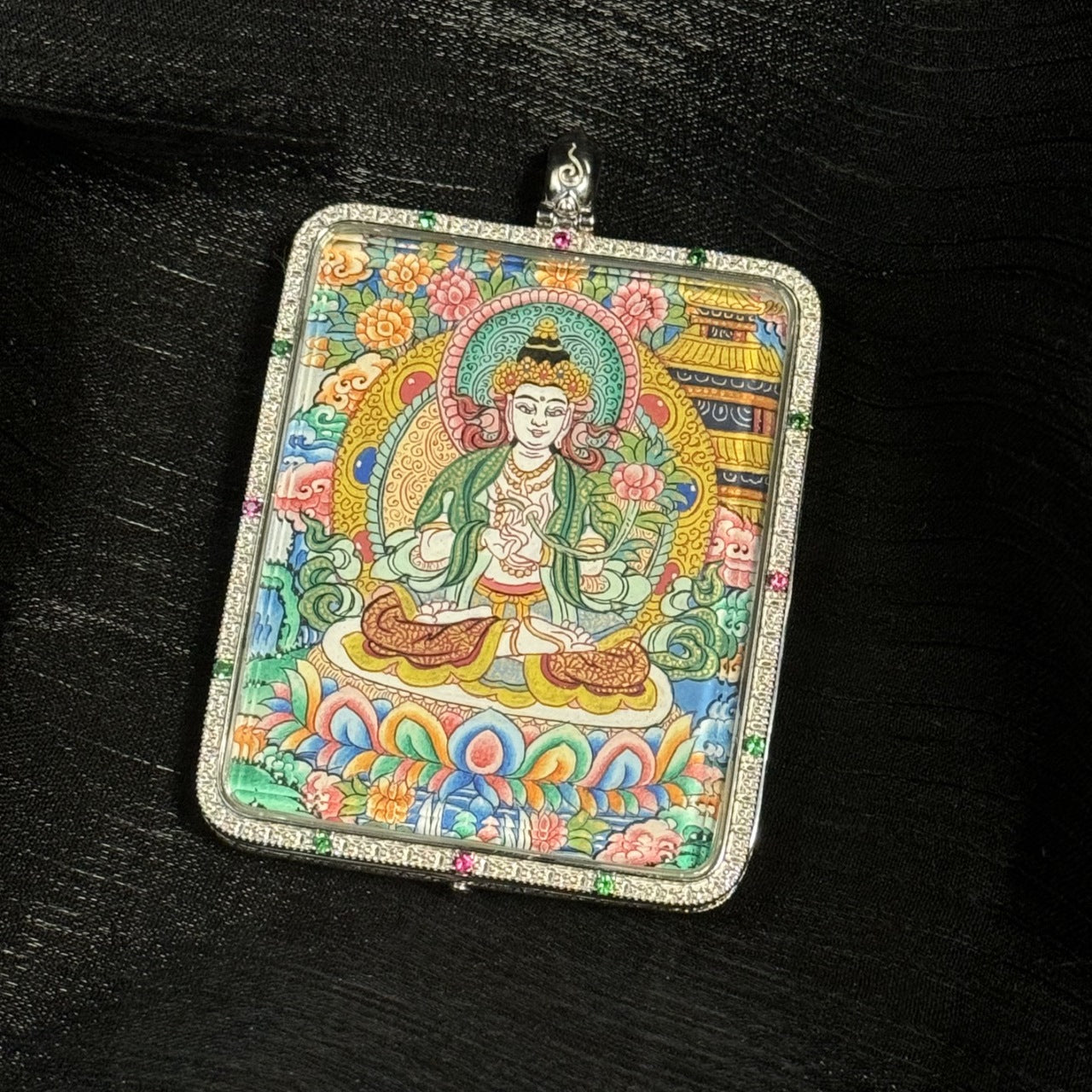 The Mahasthamaprapta with Eight Guardians and Mandala Thangka pendant displayed as a sacred amulet for joyful giving and wealth, embodying Tibetan Buddhist tradition.
