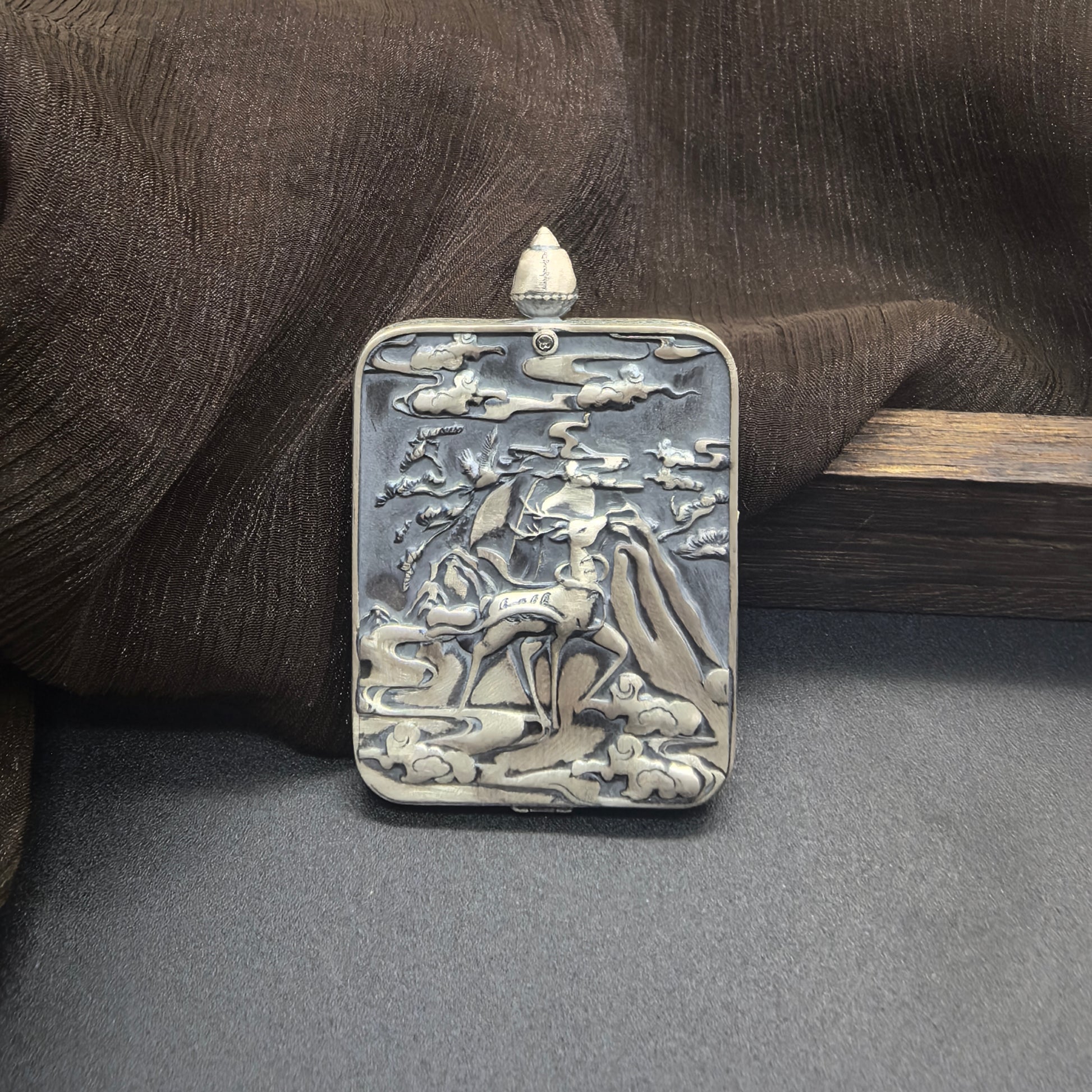Detailed view of the 925 silver casing with certificate gift box and braided cord for the Mahasthamaprapta Thangka pendant, symbolising wisdom and tradition in Buddhist practice.
