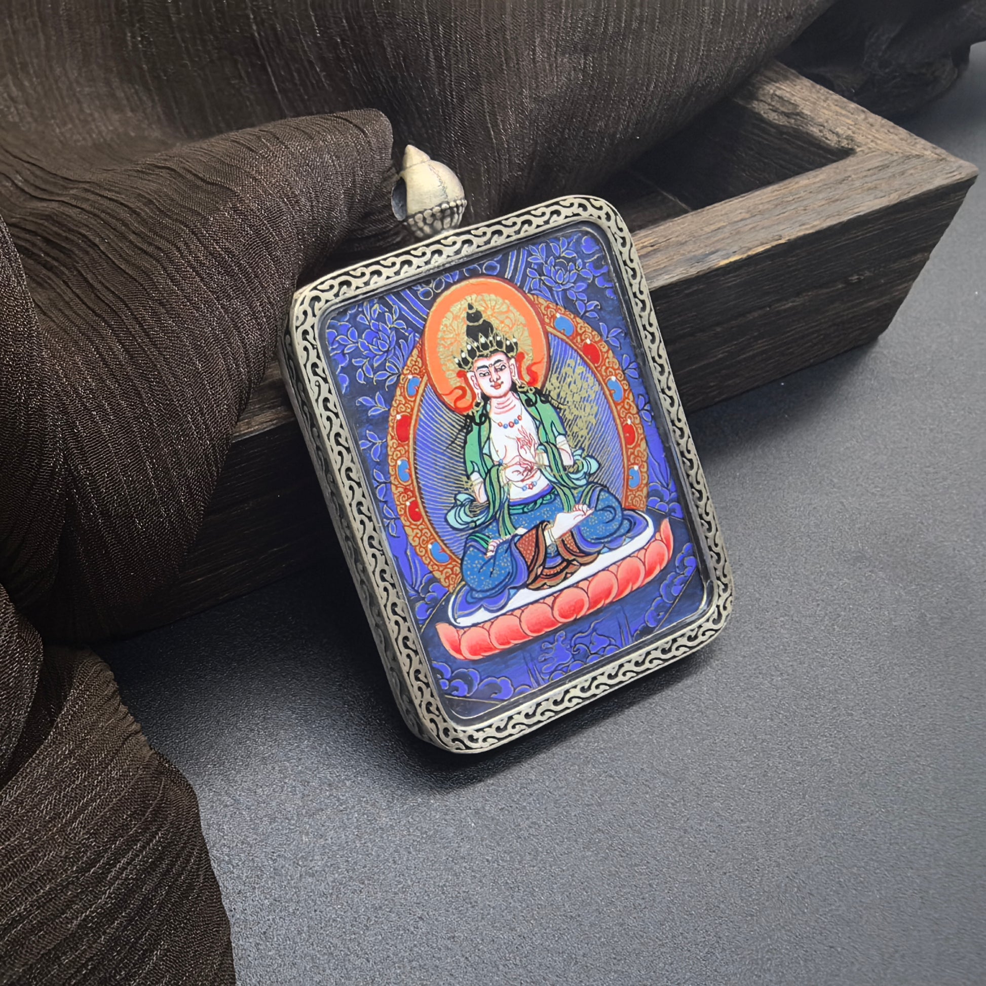  The Rekong Blue Thangka Mahasthamaprapta pendant with 925 silver displayed as a sacred amulet for wisdom and success, embodying Buddhist tradition.
