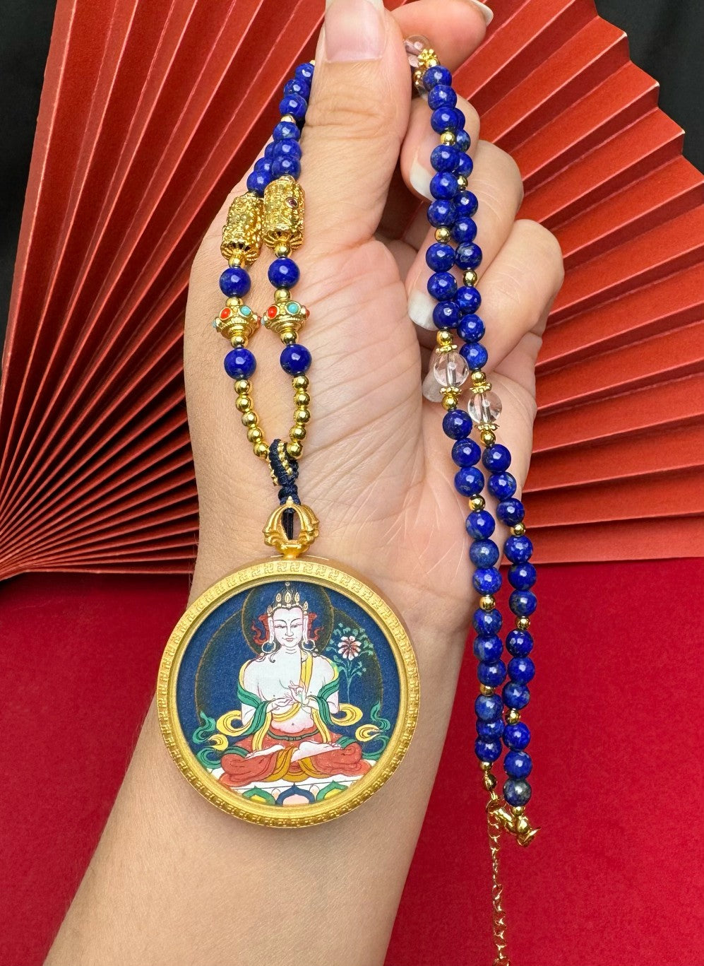 The Tibet Bold Mahasthamaprapta Thangka pendant with copper casing displayed as a sacred amulet for wisdom and success, embodying Buddhist tradition.
