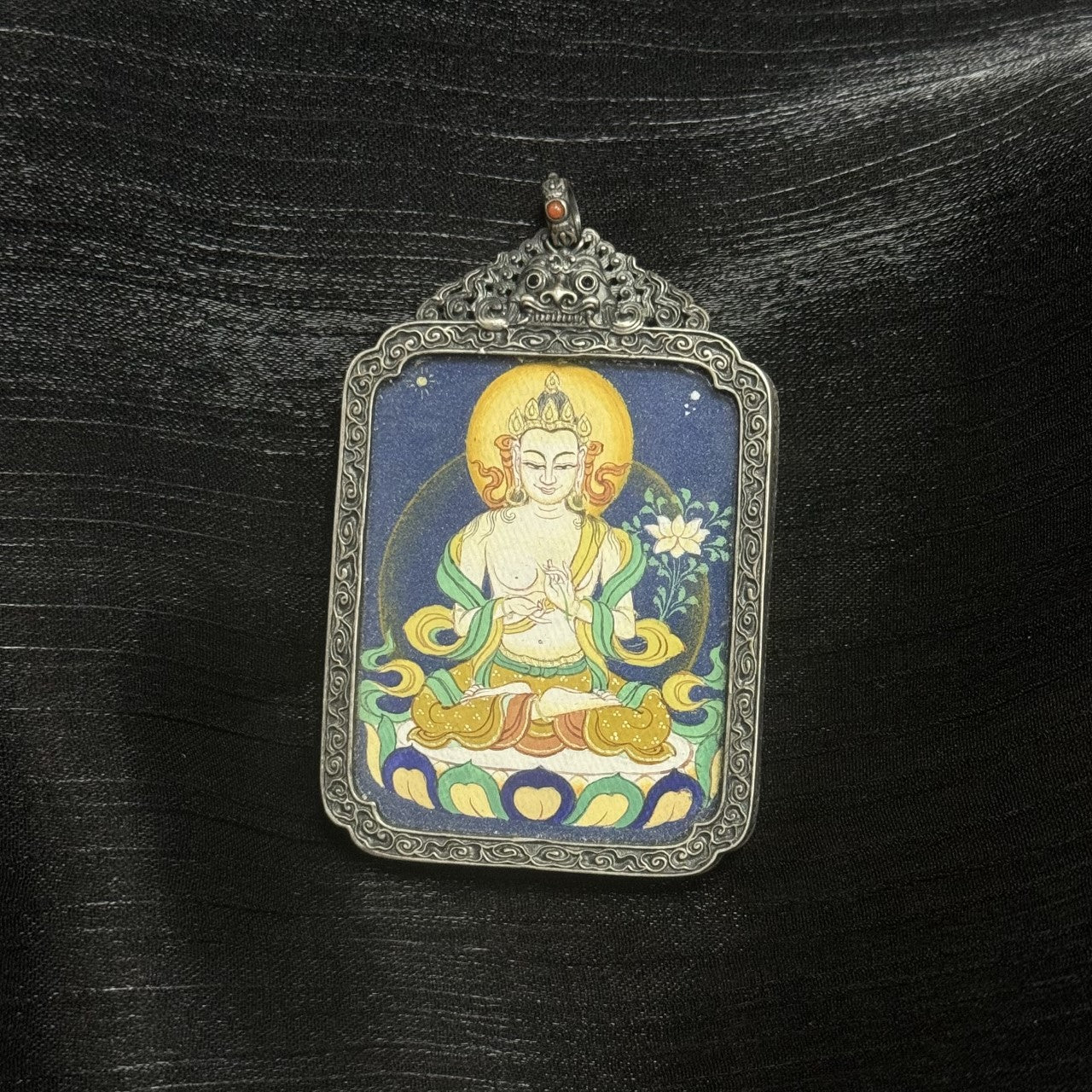 Hand-painted Tibet Coarse Mahasthamaprapta Bodhisattva Thangka pendant featuring the symbol of light and wisdom, encased in vintage silver, representing success and peace in Tibetan Buddhist tradition.
