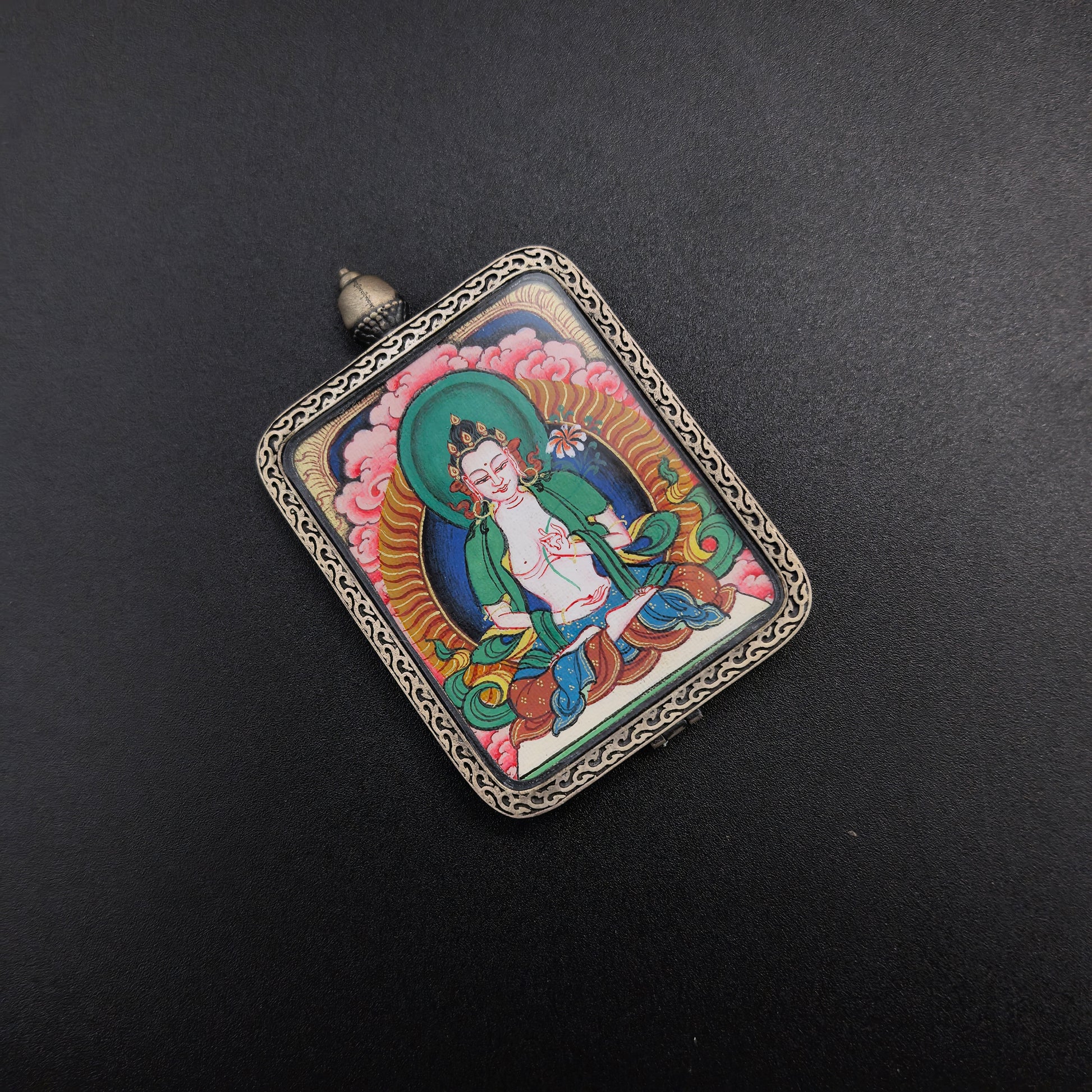 The Tibet Red Cloud Mahasthamaprapta Thangka pendant with 925 silver displayed as a sacred amulet for wisdom and success, embodying Buddhist tradition.
