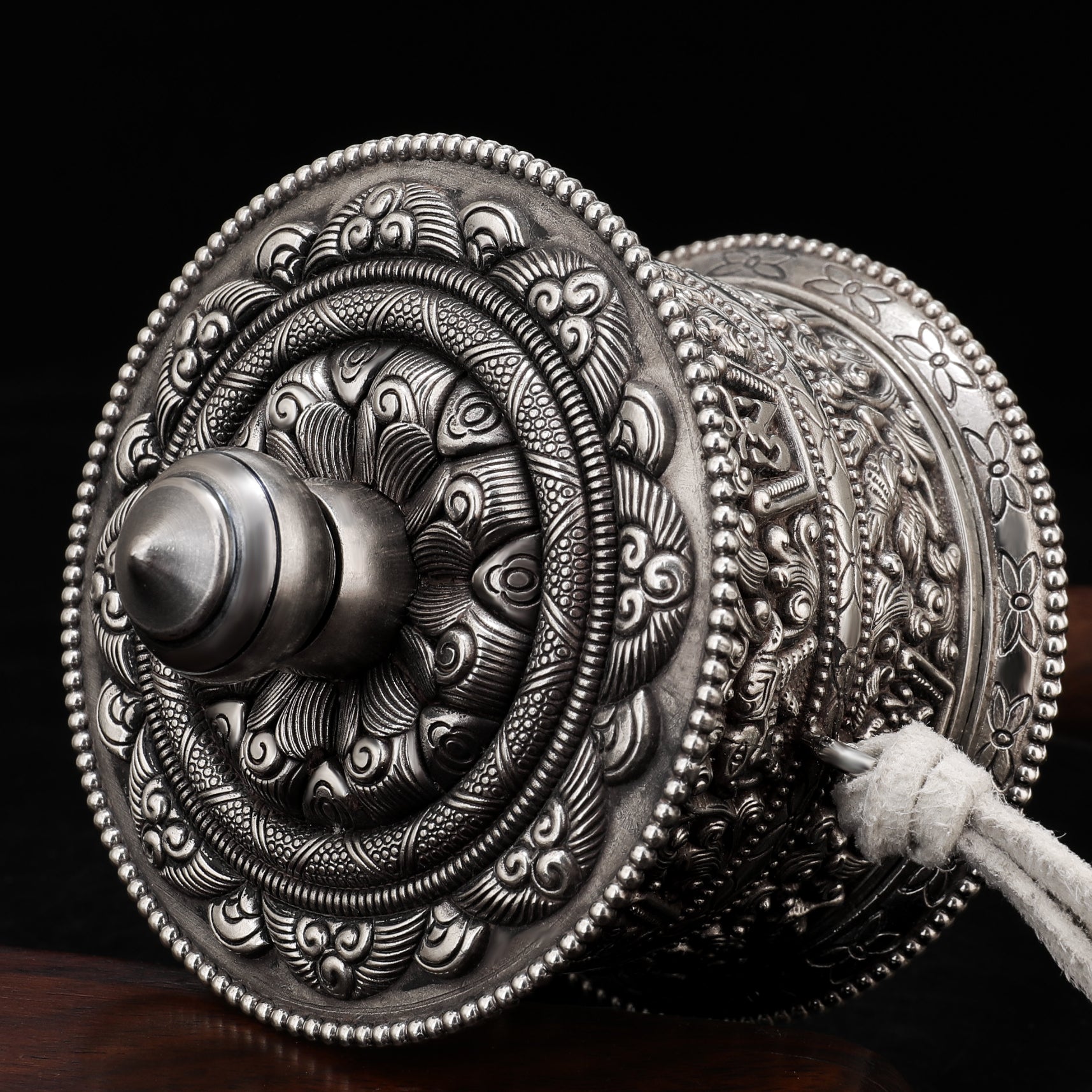 Tibetan Buddhist Mani wheel being used for spiritual practice and reciting mantras