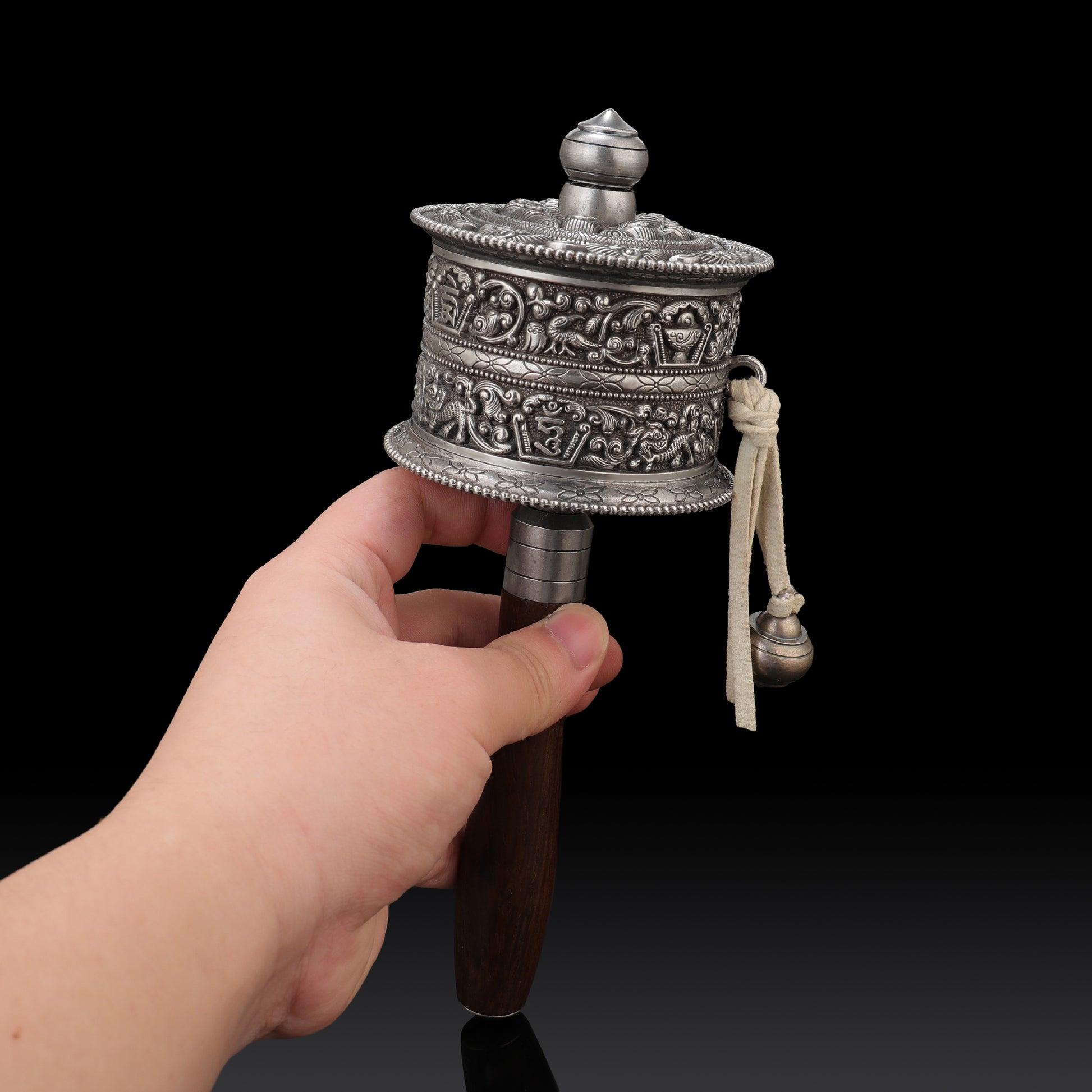 Tibetan Mani wheel with intricate metalwork, used in devotional Buddhist rituals