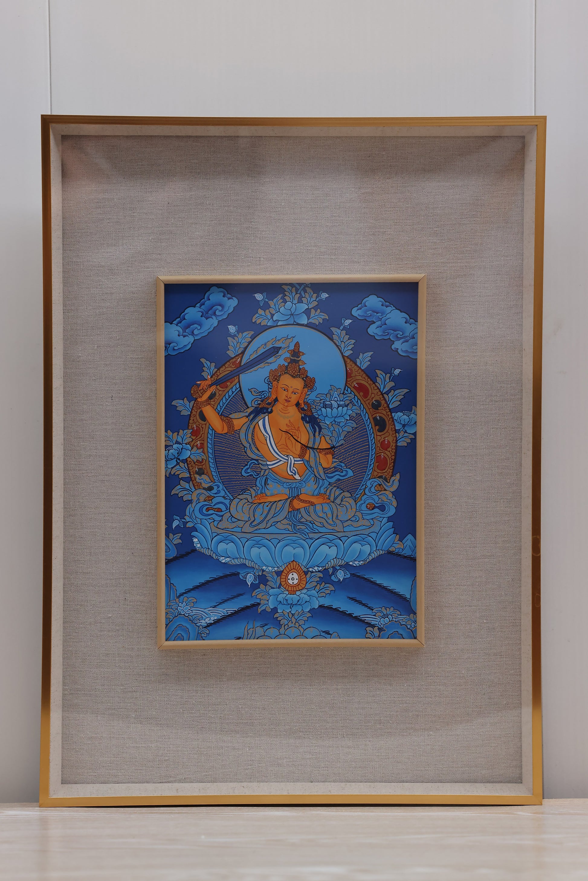 Traditional blue thangka of Manjushri Bodhisattva, a symbol of enlightenment and intellectual awakening.