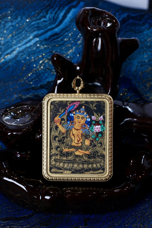 Manjushri thangka pendant representing the Bodhisattva of supreme wisdom, promoting clarity, learning, and spiritual guidance in Tibetan Buddhism.