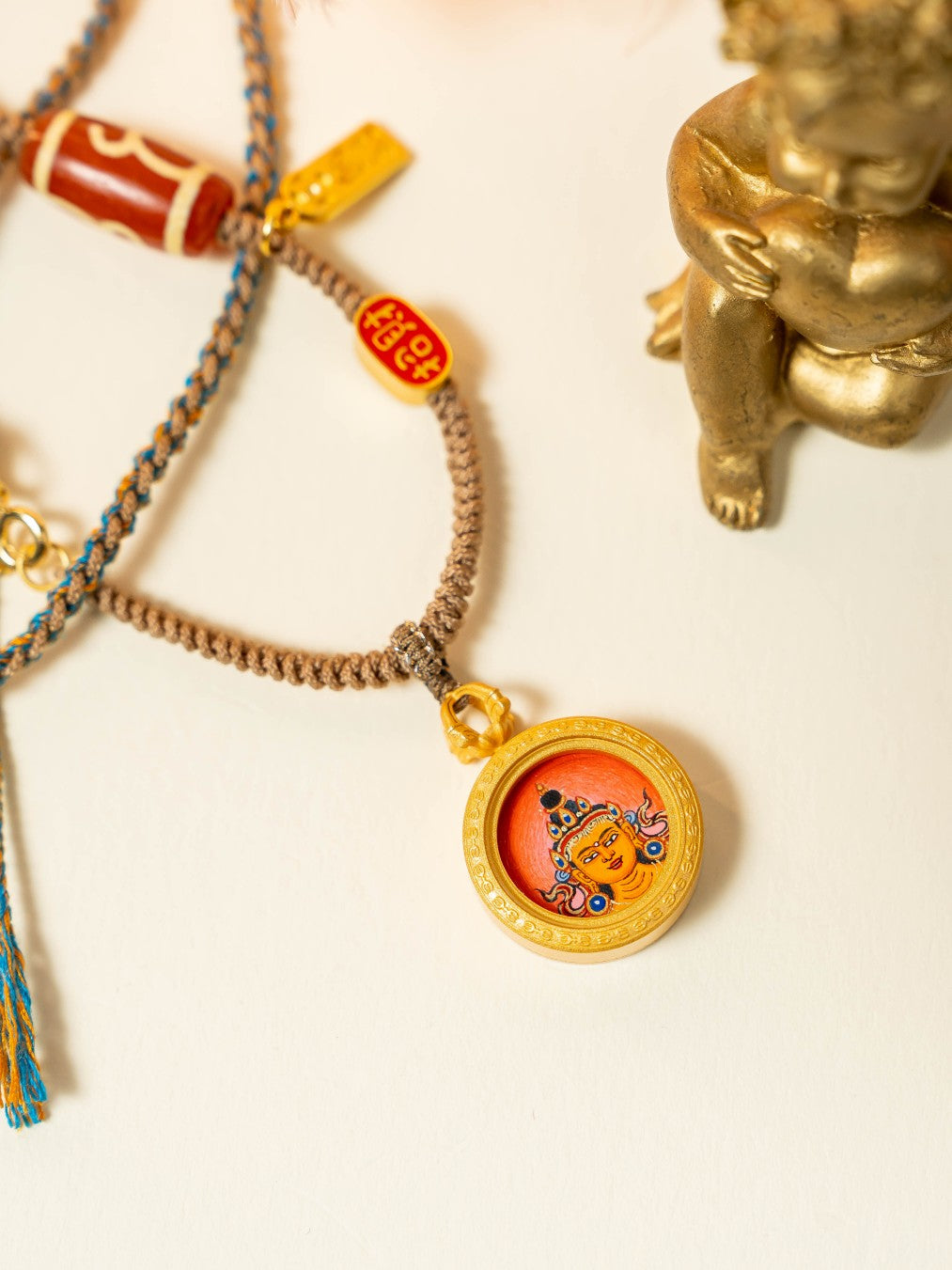  The Rekong Manjushri Buddha Thangka pendant with copper casing displayed as a sacred amulet for wisdom and academic progress, embodying Buddhist tradition.
