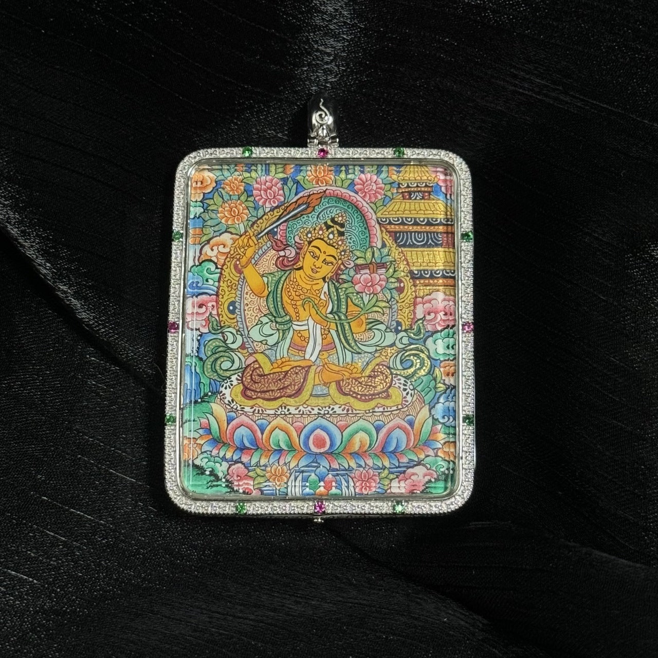  The Manjushri with Eight Guardians and Mandala Thangka pendant displayed as a sacred amulet for wisdom and success, embodying Tibetan Buddhist tradition.
