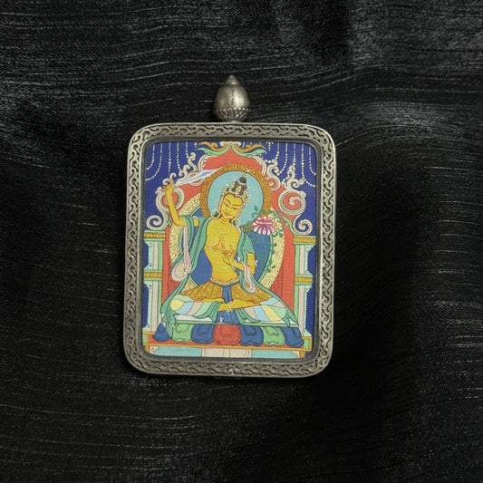  A 4x5cm hand-painted Karma Kagyu Manjushri Bodhisattva Thangka pendant featuring the Bodhisattva of Wisdom, encased in 925 silver Dunhuang Nine-Colour Deer casing, representing wisdom and success in Tibetan Buddhist tradition.
