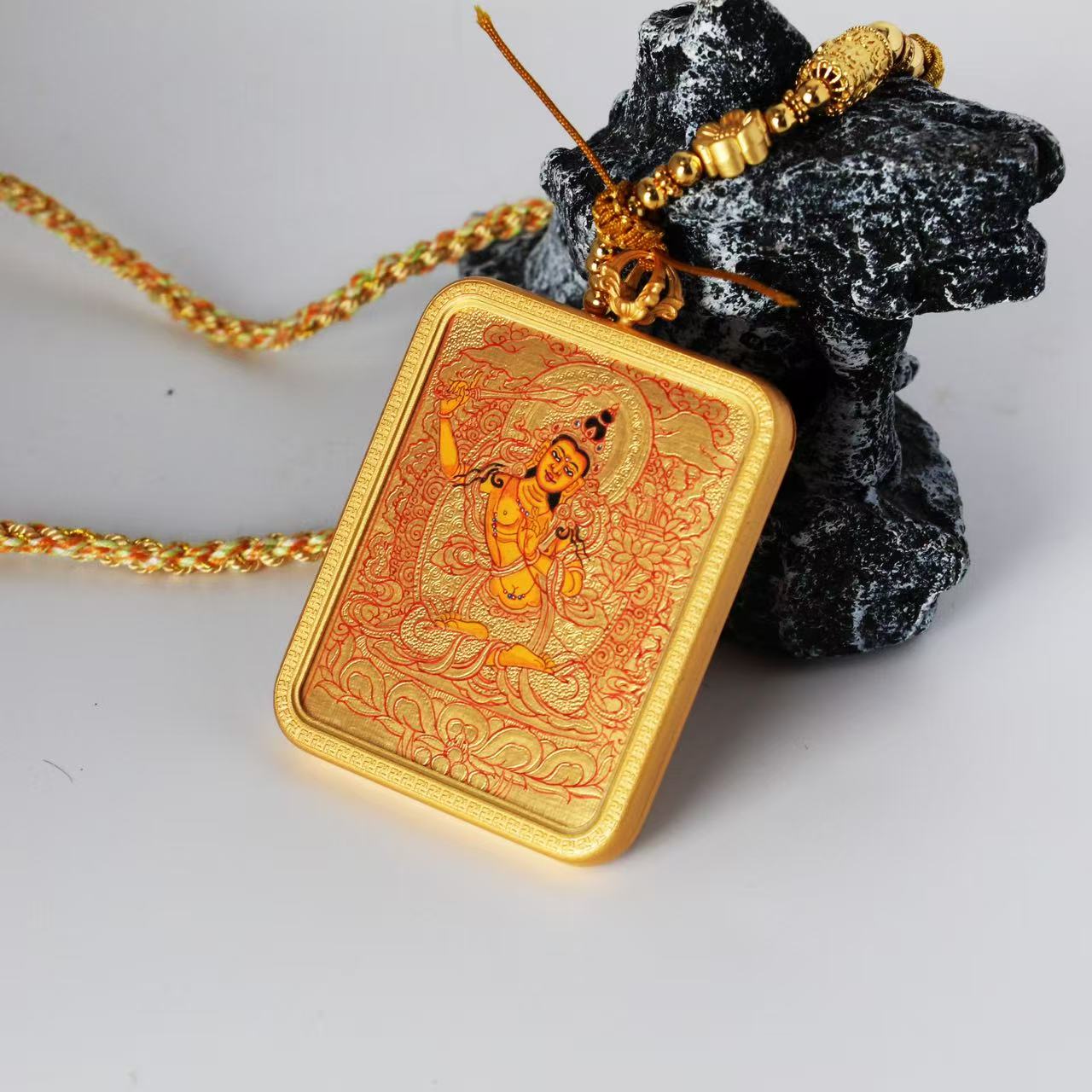  The Karma Kagyu Manjushri Thangka pendant displayed as a sacred amulet for wisdom and learning, embodying the sword of wisdom of Tibetan Buddhist tradition.
