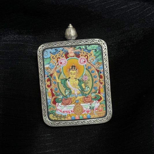  Close-up detail of the Menri Manjushri Thangka painting showing intricate natural mineral pigment work and symbolic attributes, showcasing the artistry of Tibetan lineage painters.
