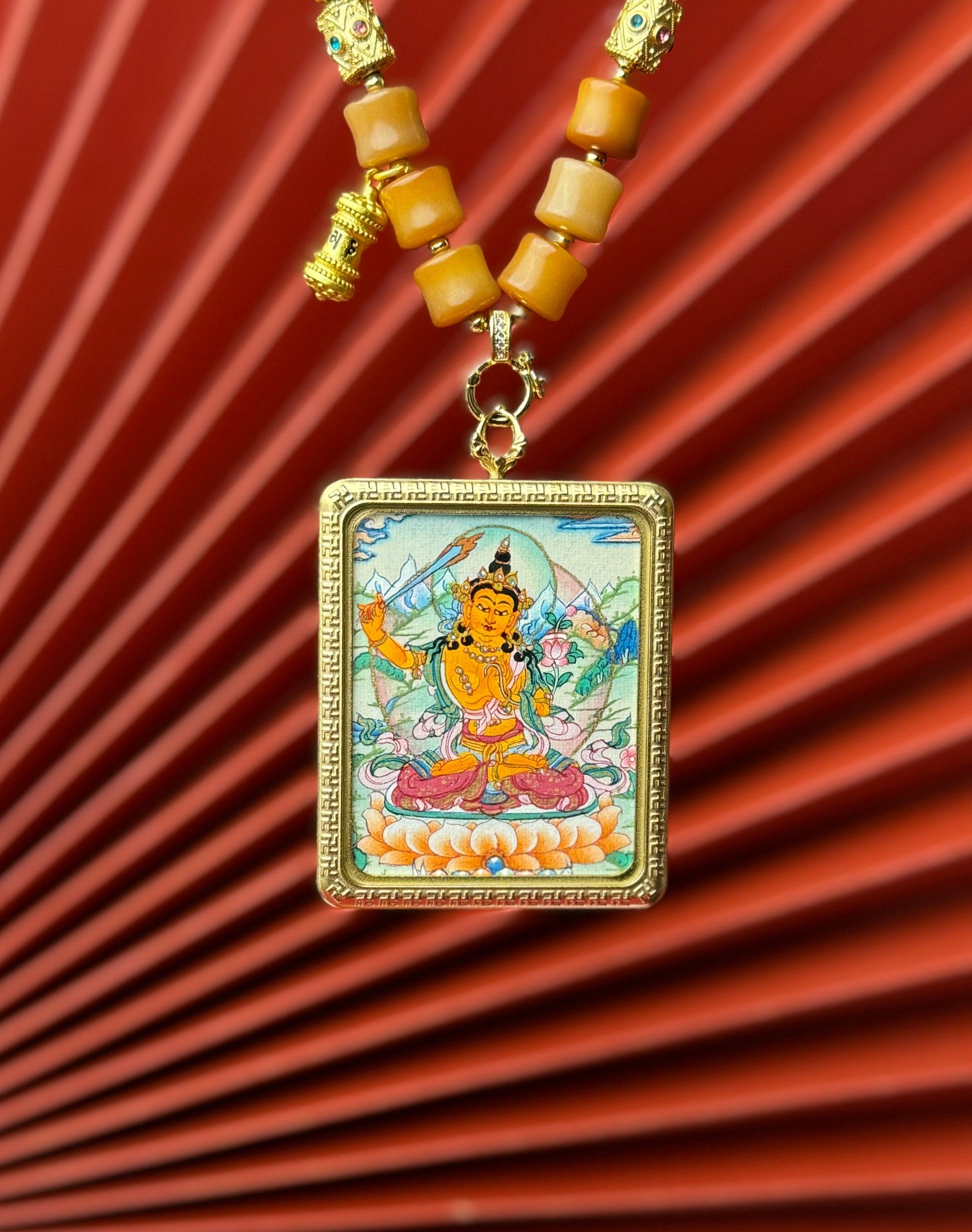  Detailed view of the titanium casing for the Manjushri Thangka pendant, symbolising wisdom and tradition in Buddhist practice.
