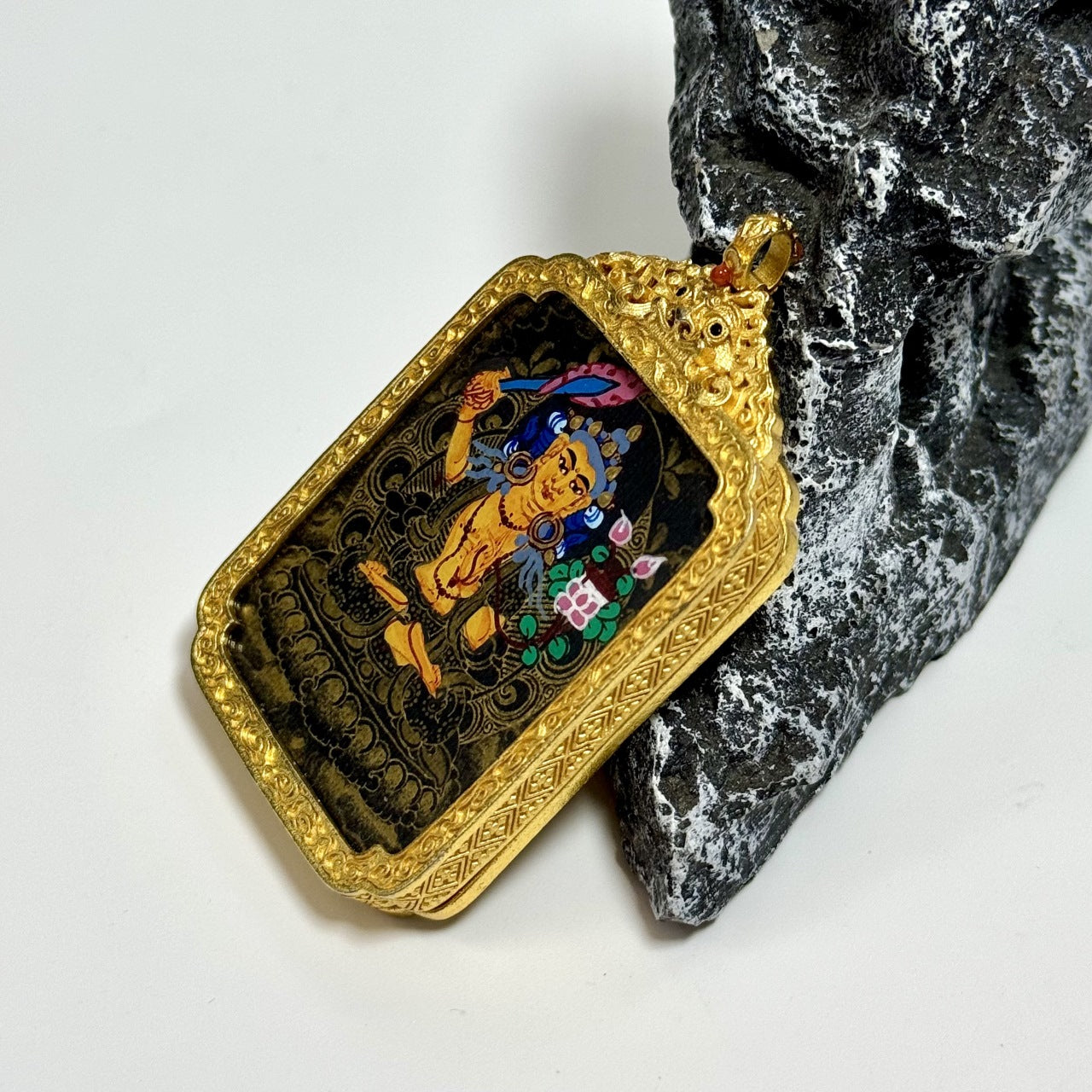 Hand-painted Nepal Black Gold Manjushri Thangka pendant featuring the Bodhisattva of Wisdom, copper casing, representing wisdom and merit in Tibetan Buddhist tradition.
