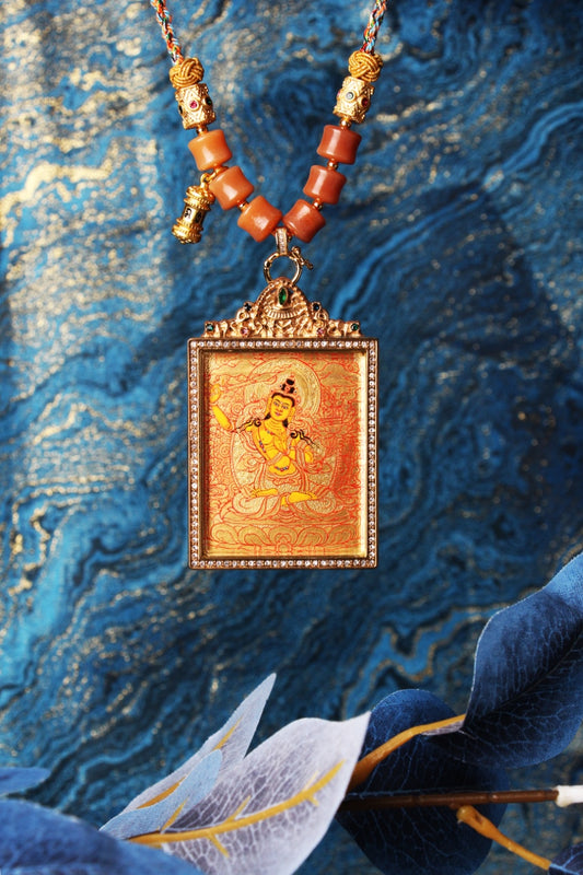  The Rebgong Manjushri Thangka pendant displayed as a sacred amulet for wisdom and learning, embodying the sword of wisdom of Tibetan Buddhist tradition.

