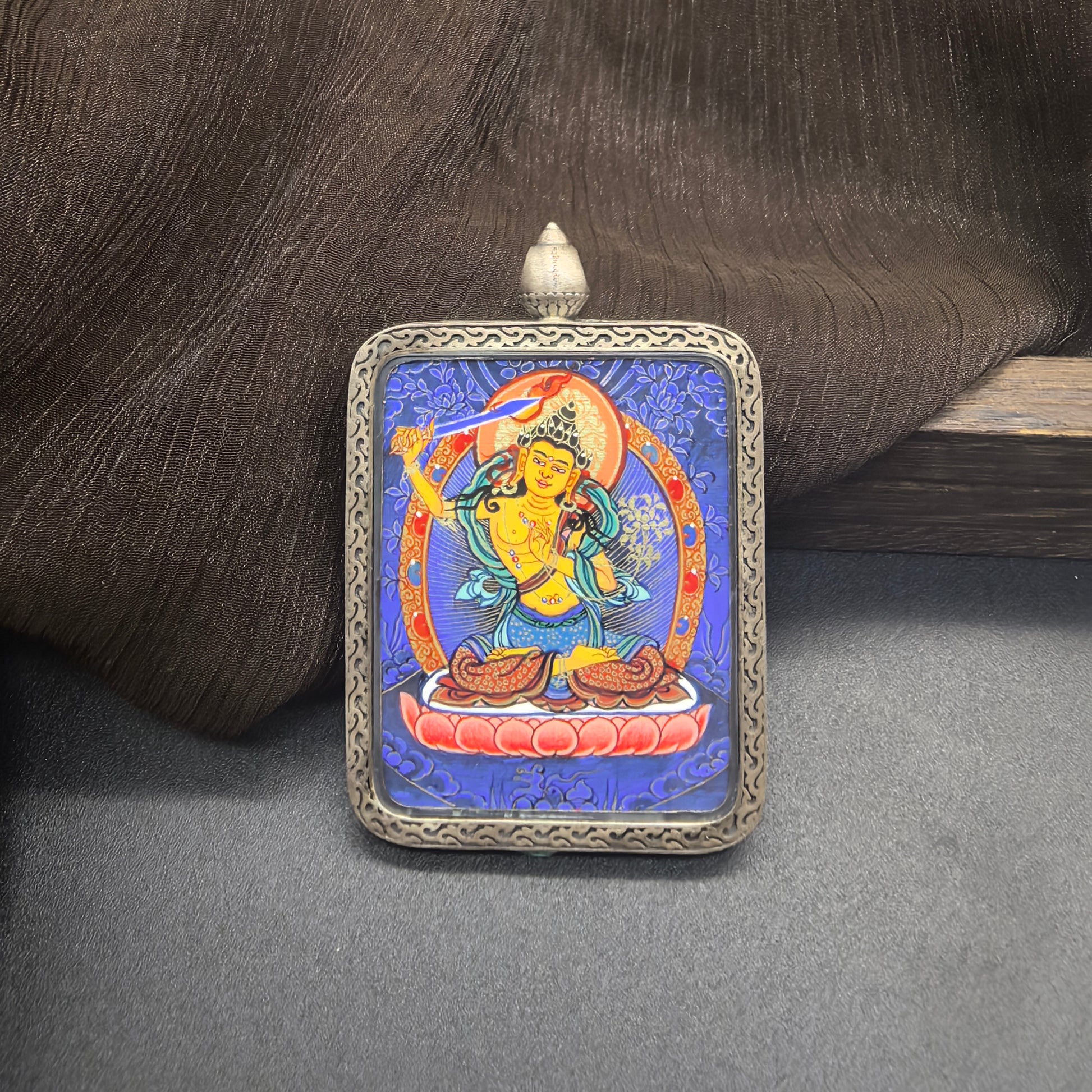  Close-up detail of the Rekong Blue Thangka Manjushri painting showing natural mineral pigments, showcasing the masterful artistry of Rekong lama painters.
